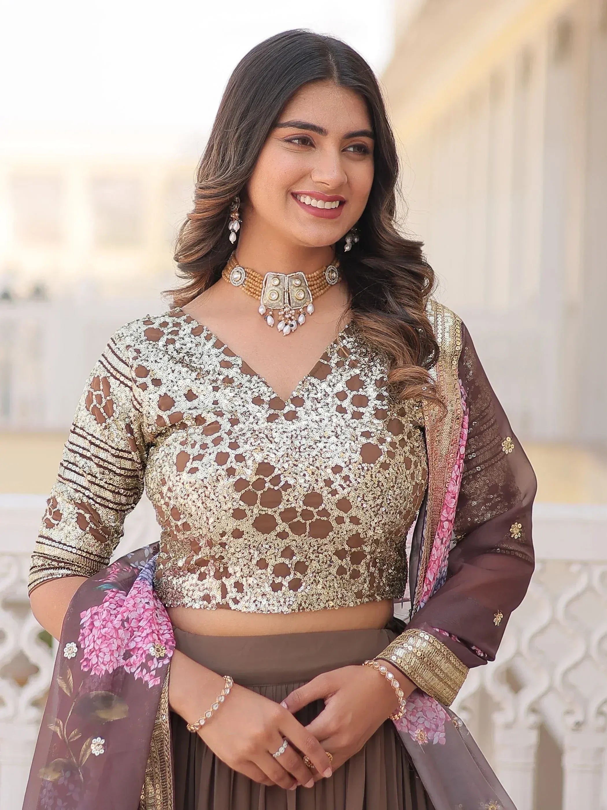 Elegant woman in sequined ethnic crop top with floral dupatta, perfect for Indian festive occasions