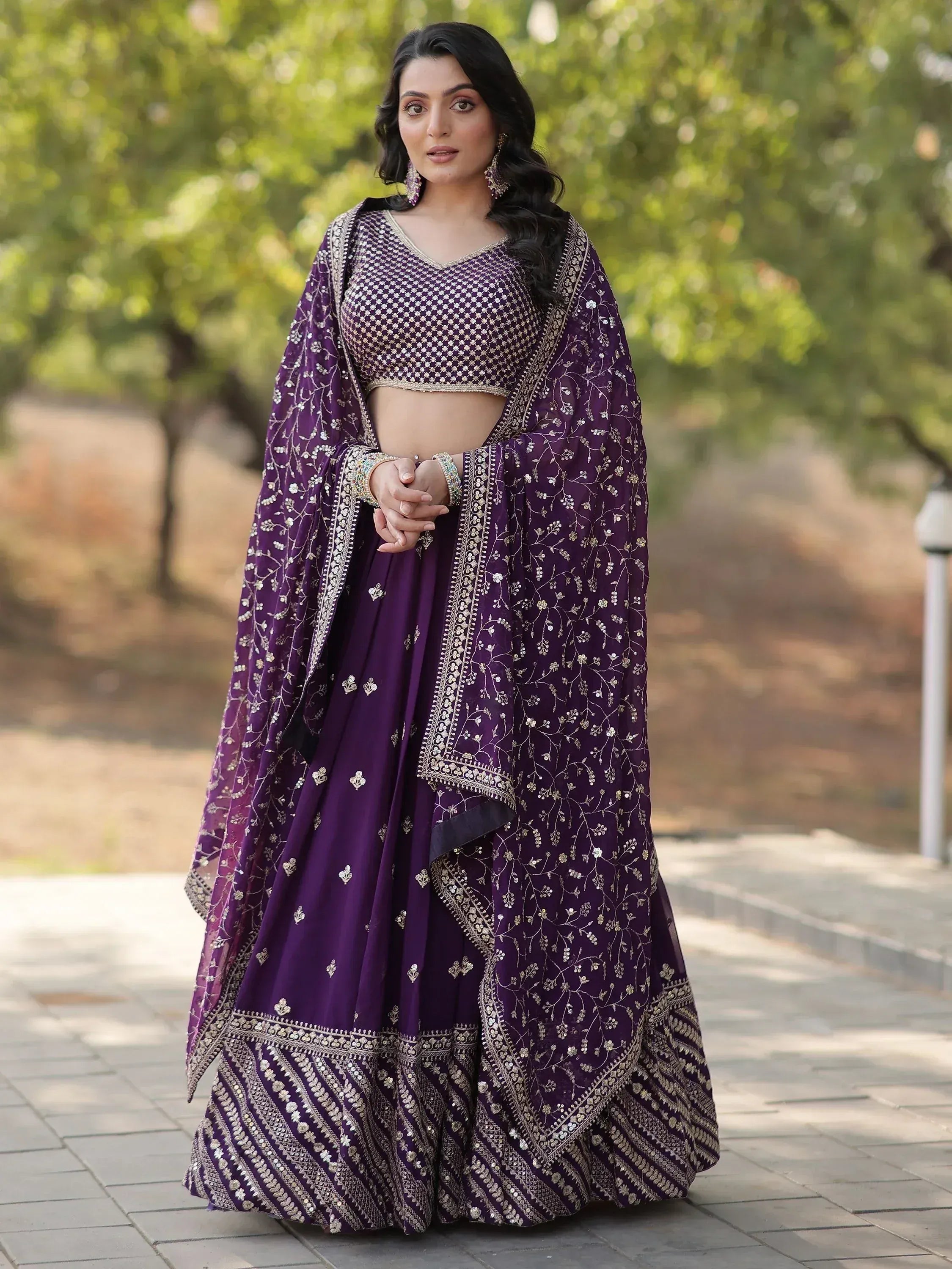 Purple embroidered lehenga choli with floral zari work, perfect for Indian weddings and festive occasions