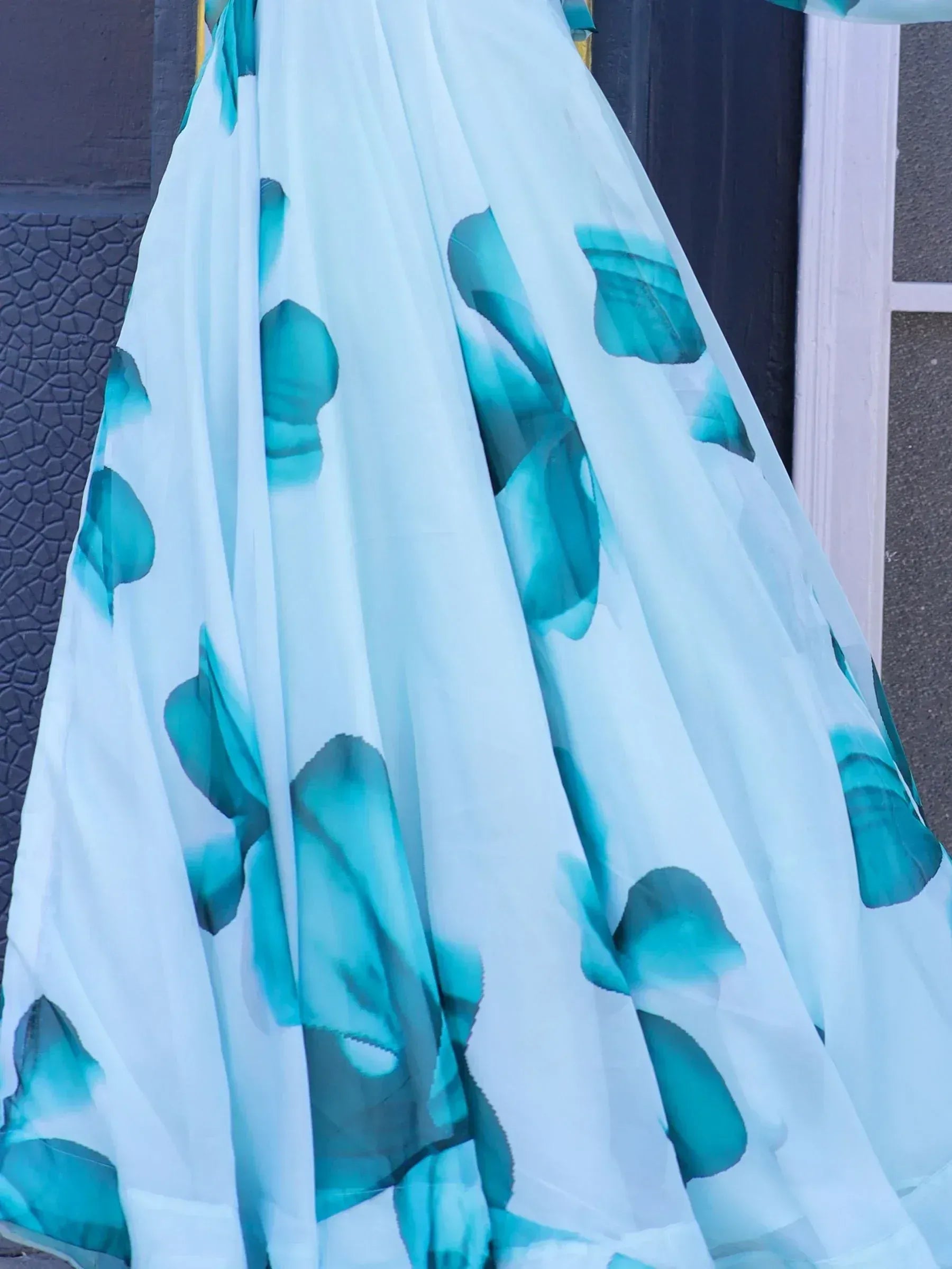 White ethnic gown with teal floral print, lightweight fabric, perfect for Indian occasions