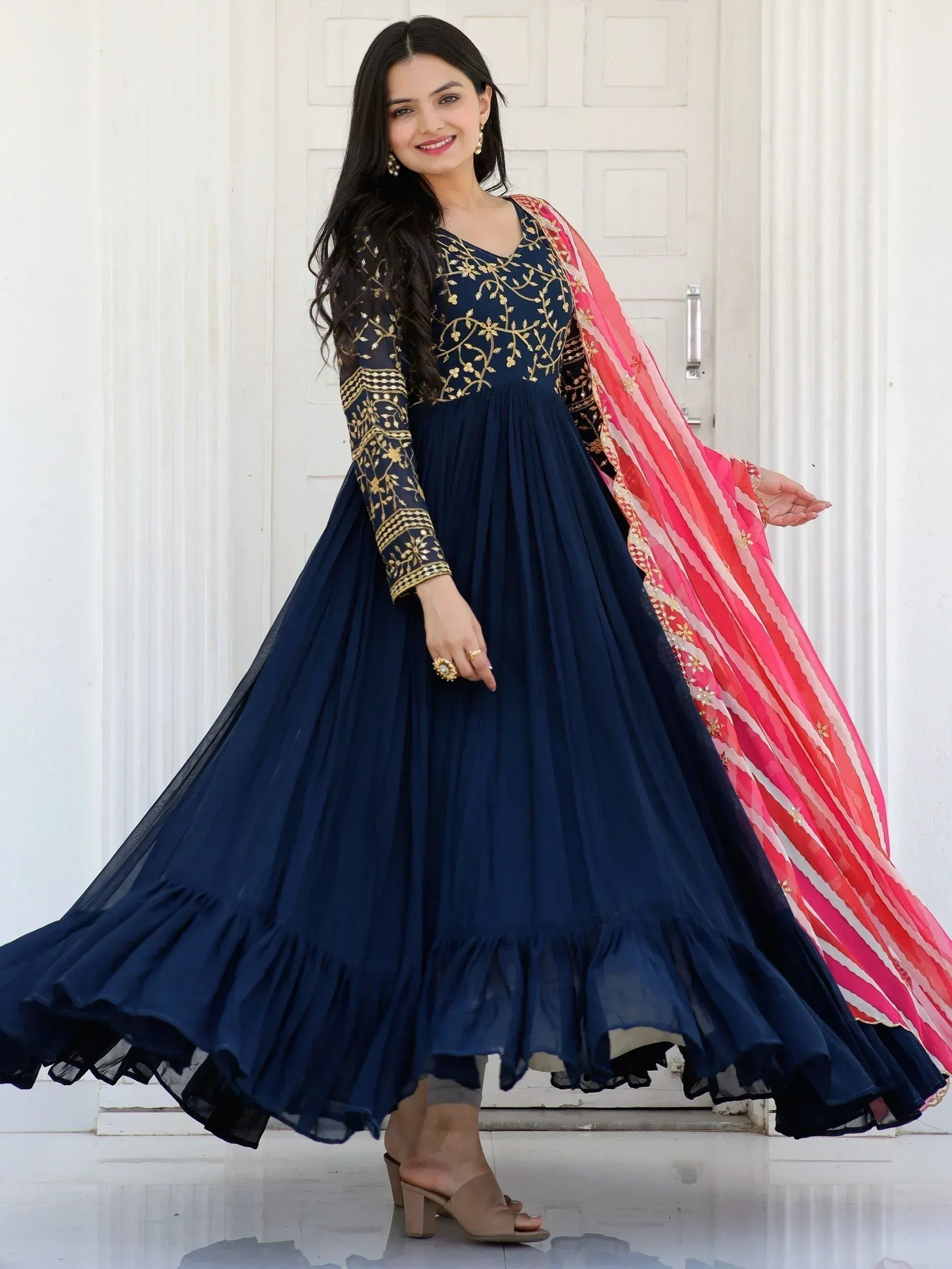 Navy blue embroidered anarkali gown with gold detailing and pink dupatta, perfect for Indian ethnic wear occasions.