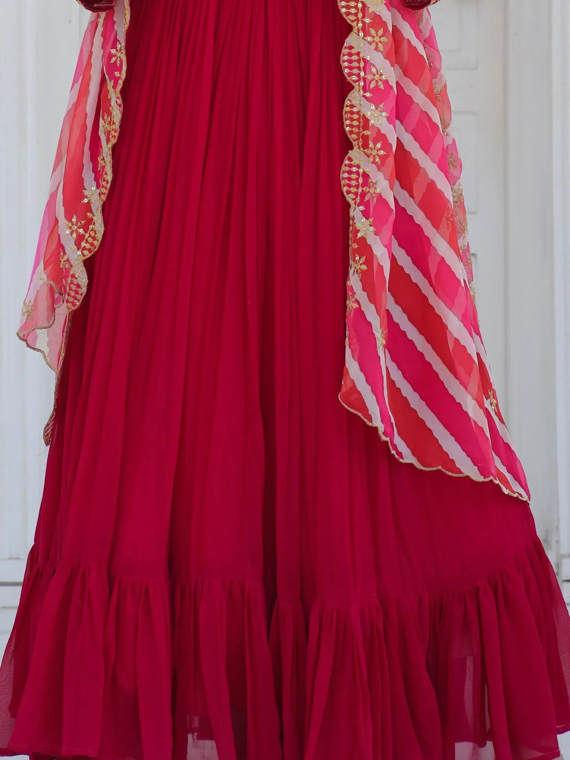 Red ethnic lehenga with gold embroidery and pink striped dupatta, perfect for Indian weddings and festivals