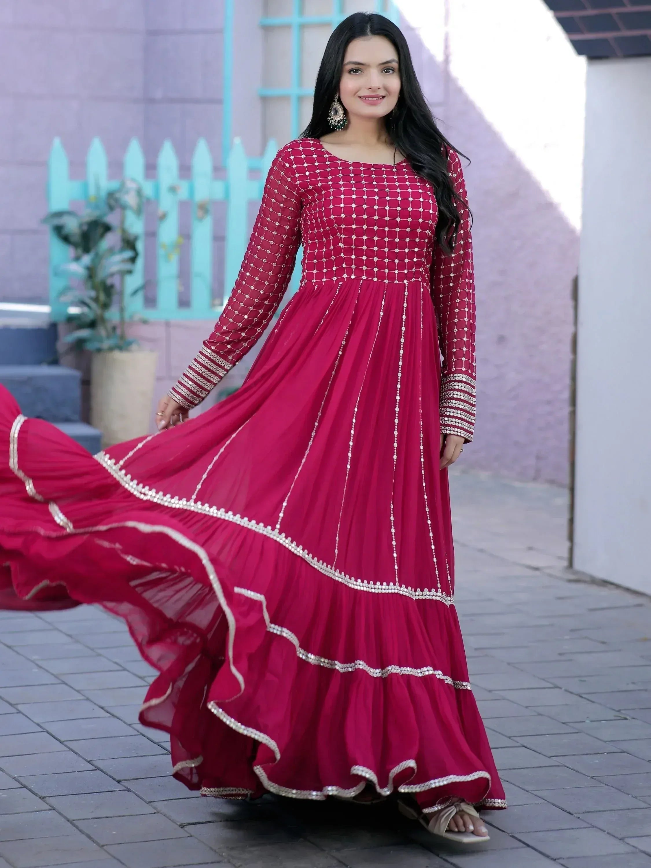 Woman in elegant maroon ethnic gown with silver embroidery, perfect for Indian occasions