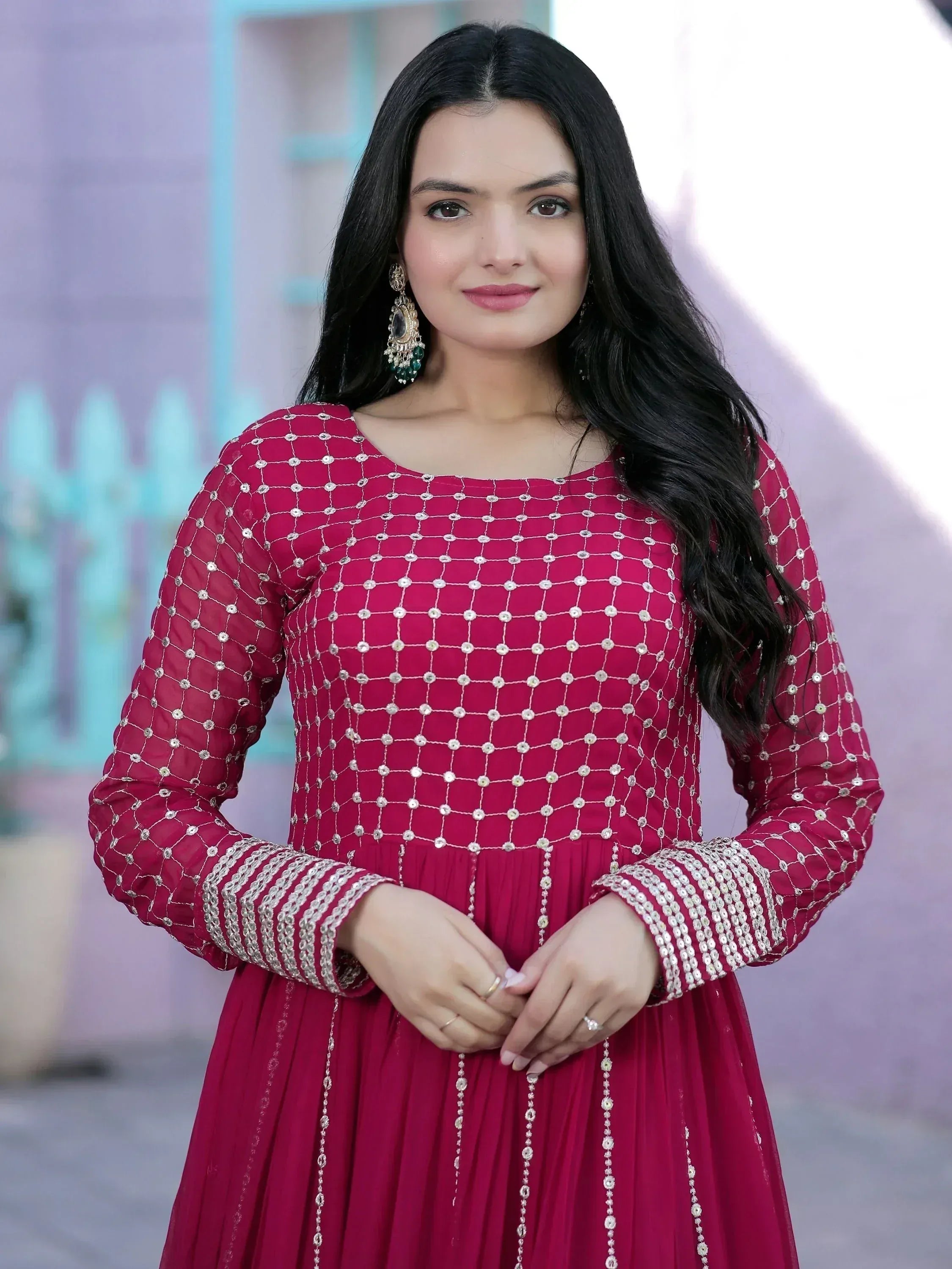 Woman in maroon ethnic gown with silver mirror work and pleated skirt, perfect for Indian occasions
