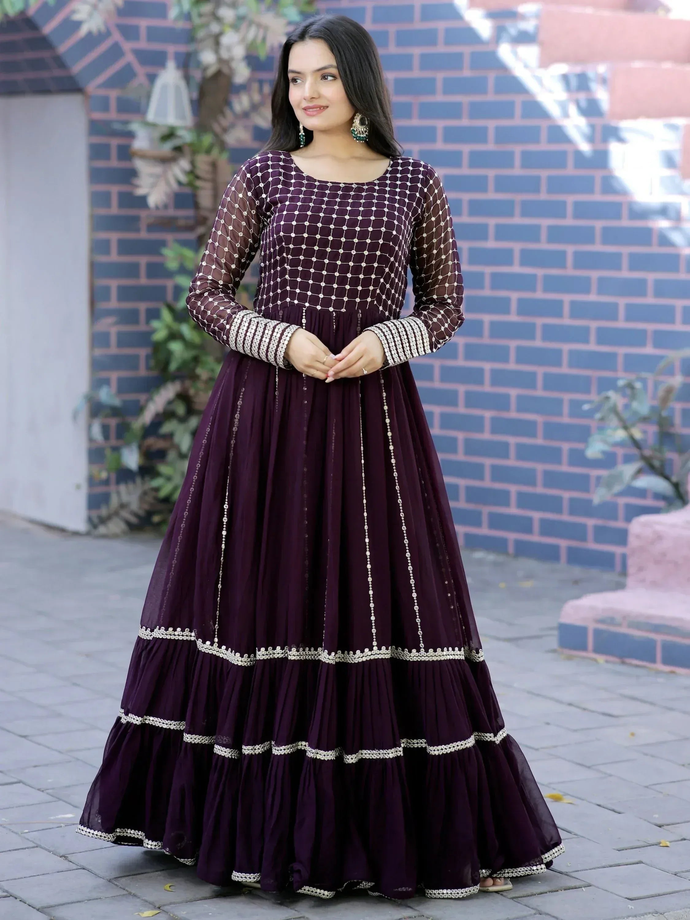 Elegant purple ethnic gown with intricate embroidery and layered skirt, perfect for Indian festive occasions.