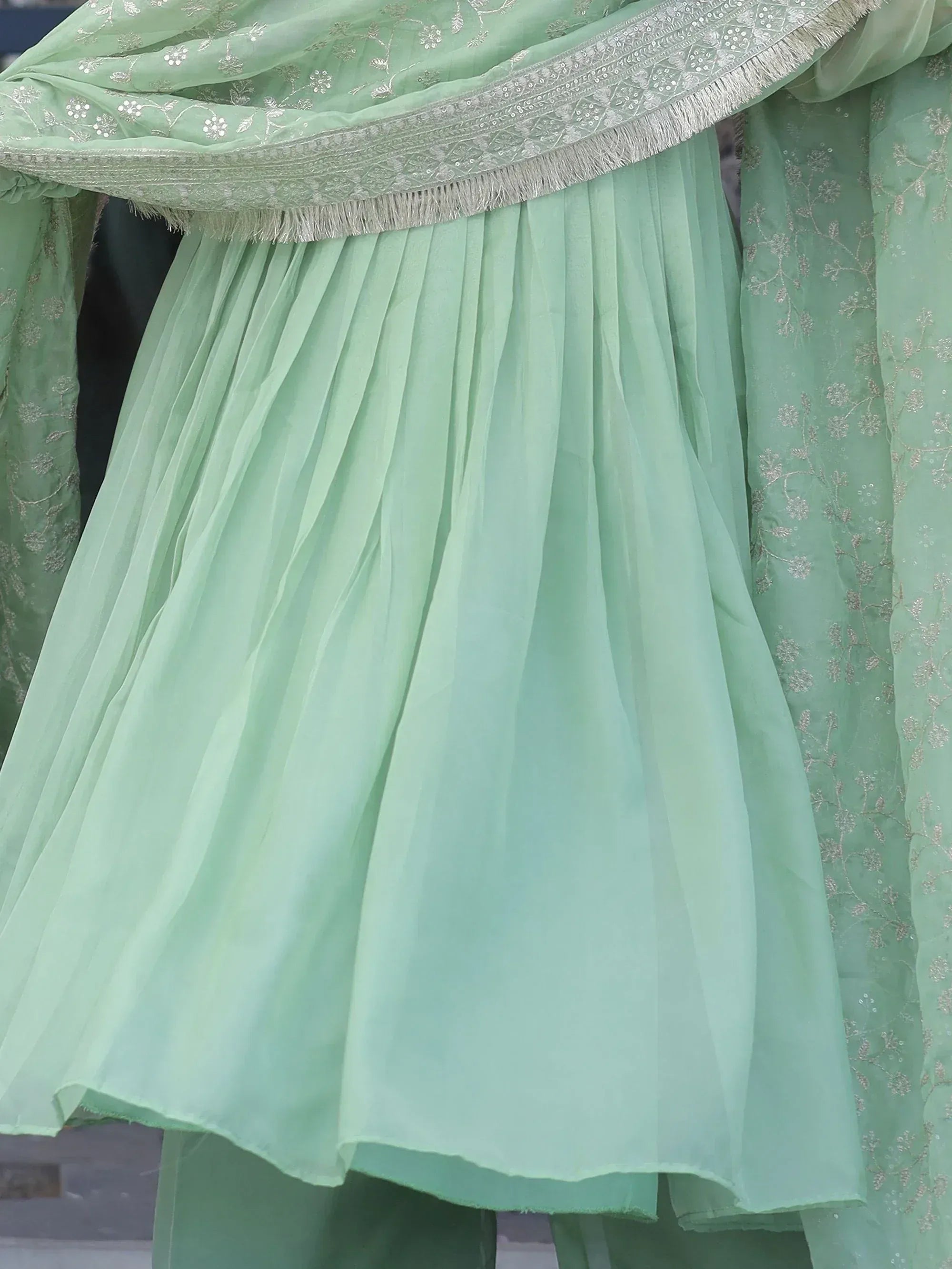Mint green ethnic sharara set with floral embroidery and pleated skirt, perfect for Indian occasions.
