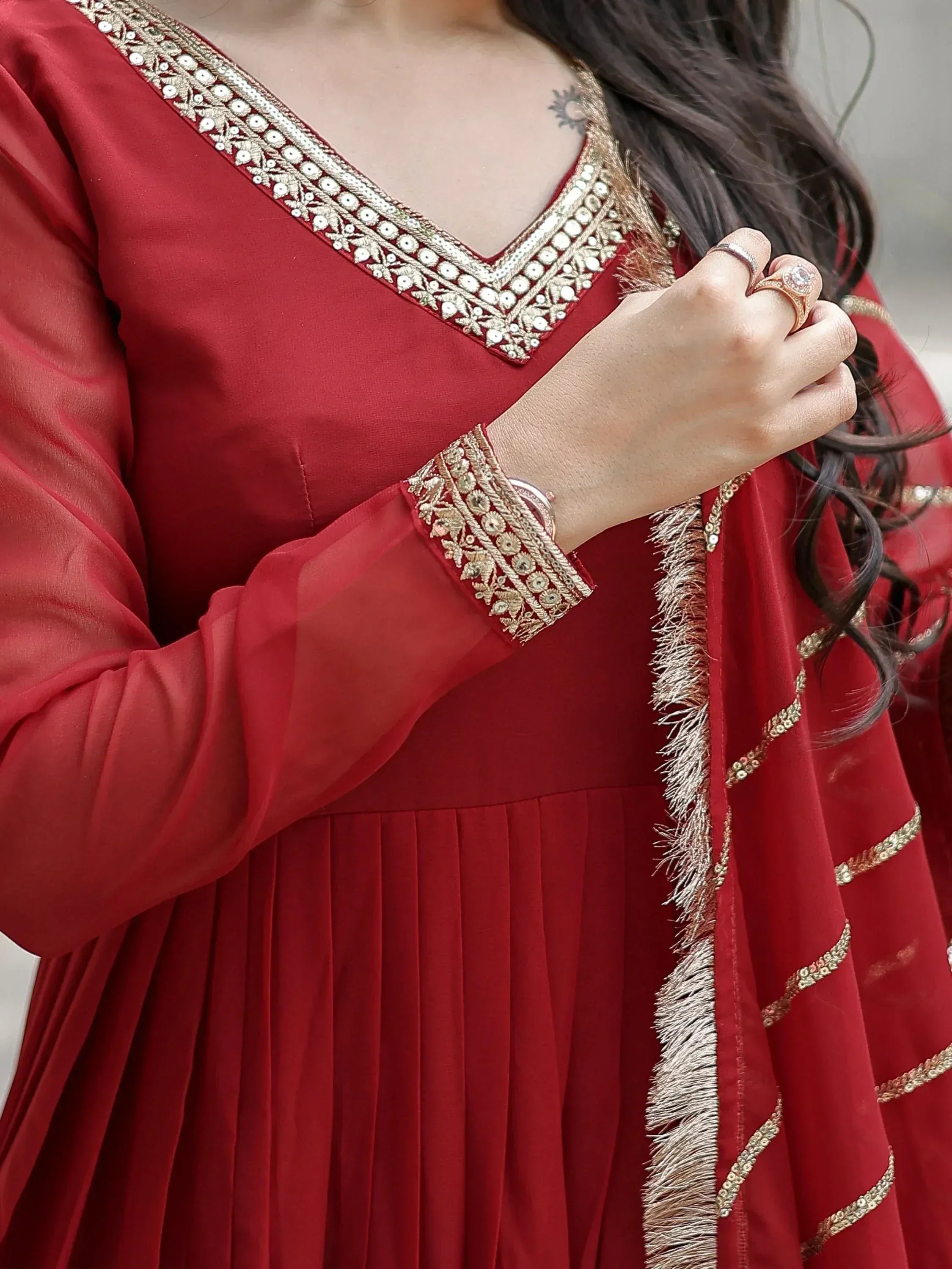 Red ethnic gown with gold embroidery and mirror work, perfect for Indian festive occasions