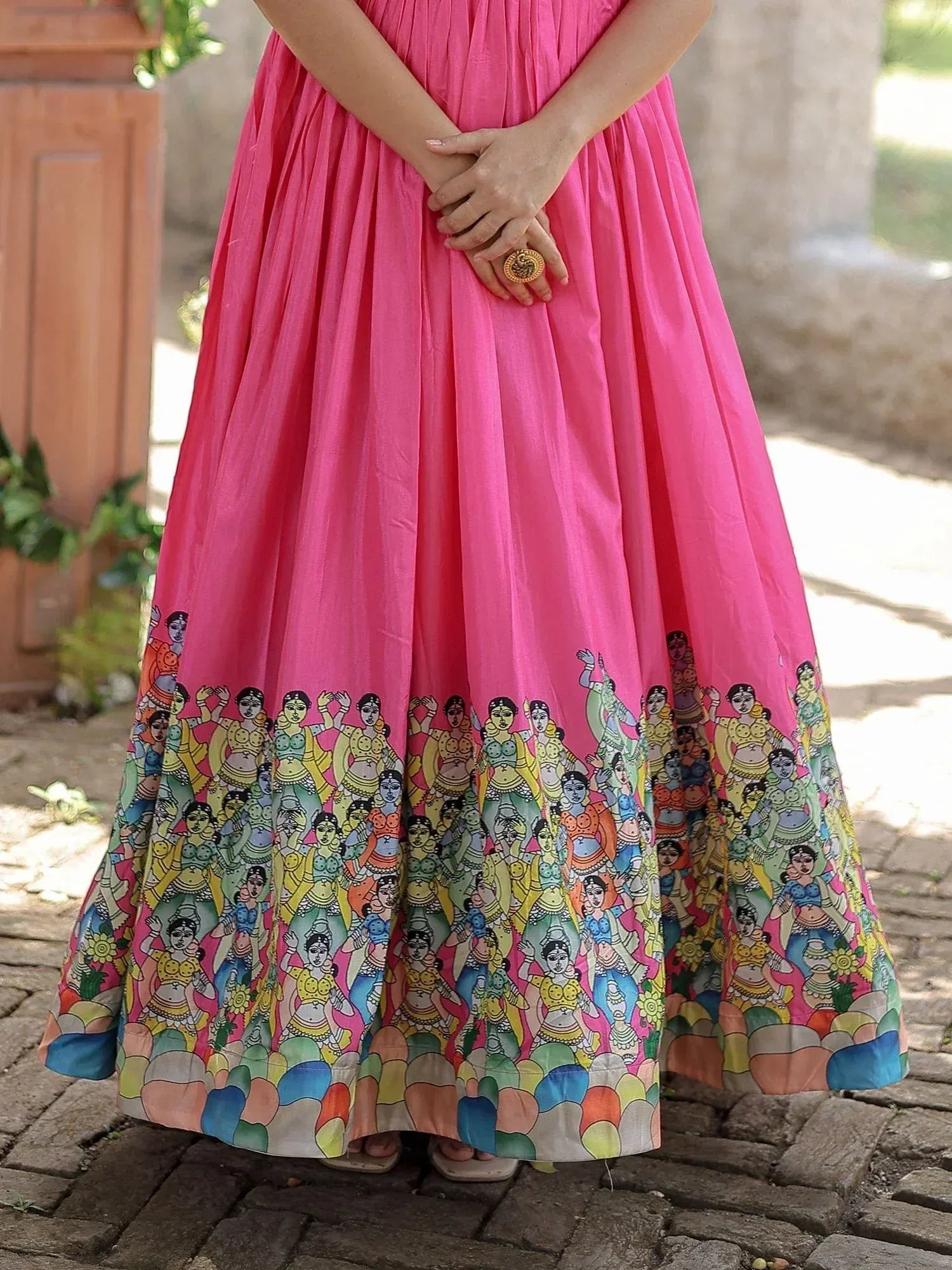 Pink ethnic gown with colorful folk dancer print, perfect for Indian celebrations and events.
