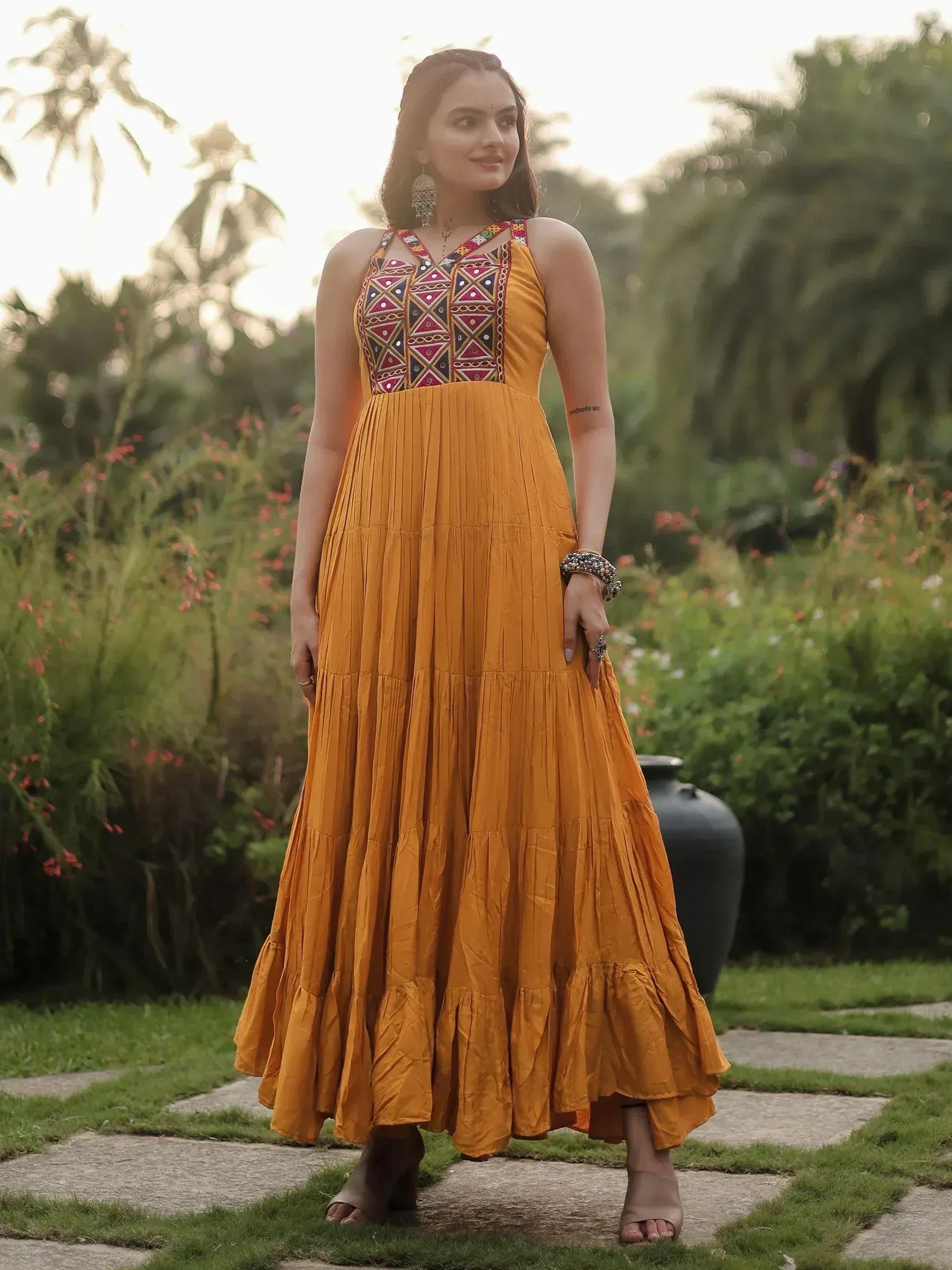 Mustard yellow ethnic gown with embroidered bodice, pleated tiered skirt, perfect for Indian occasions