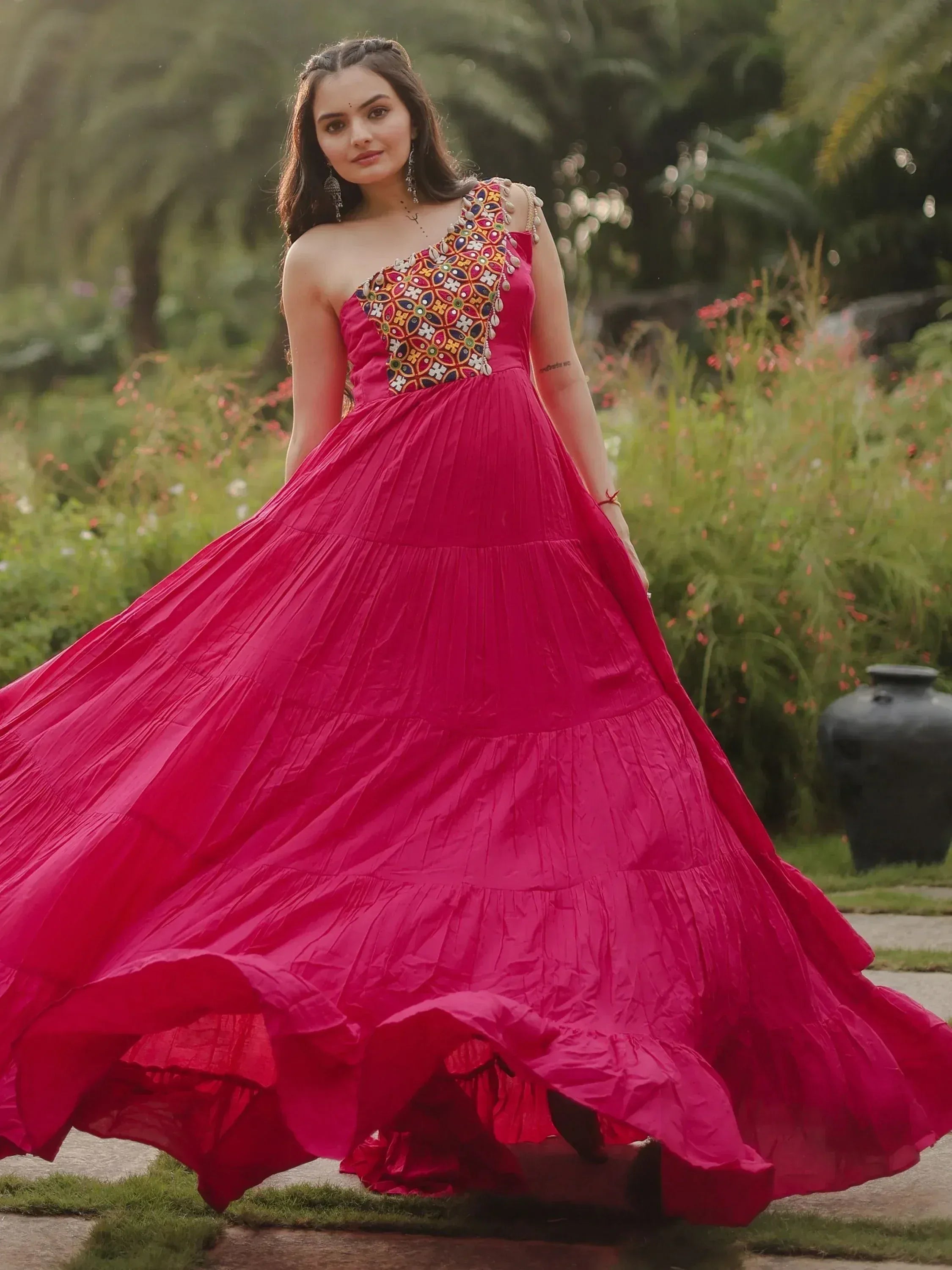 Fuchsia ethnic gown with embroidered one-shoulder design, perfect for Indian weddings and festive occasions