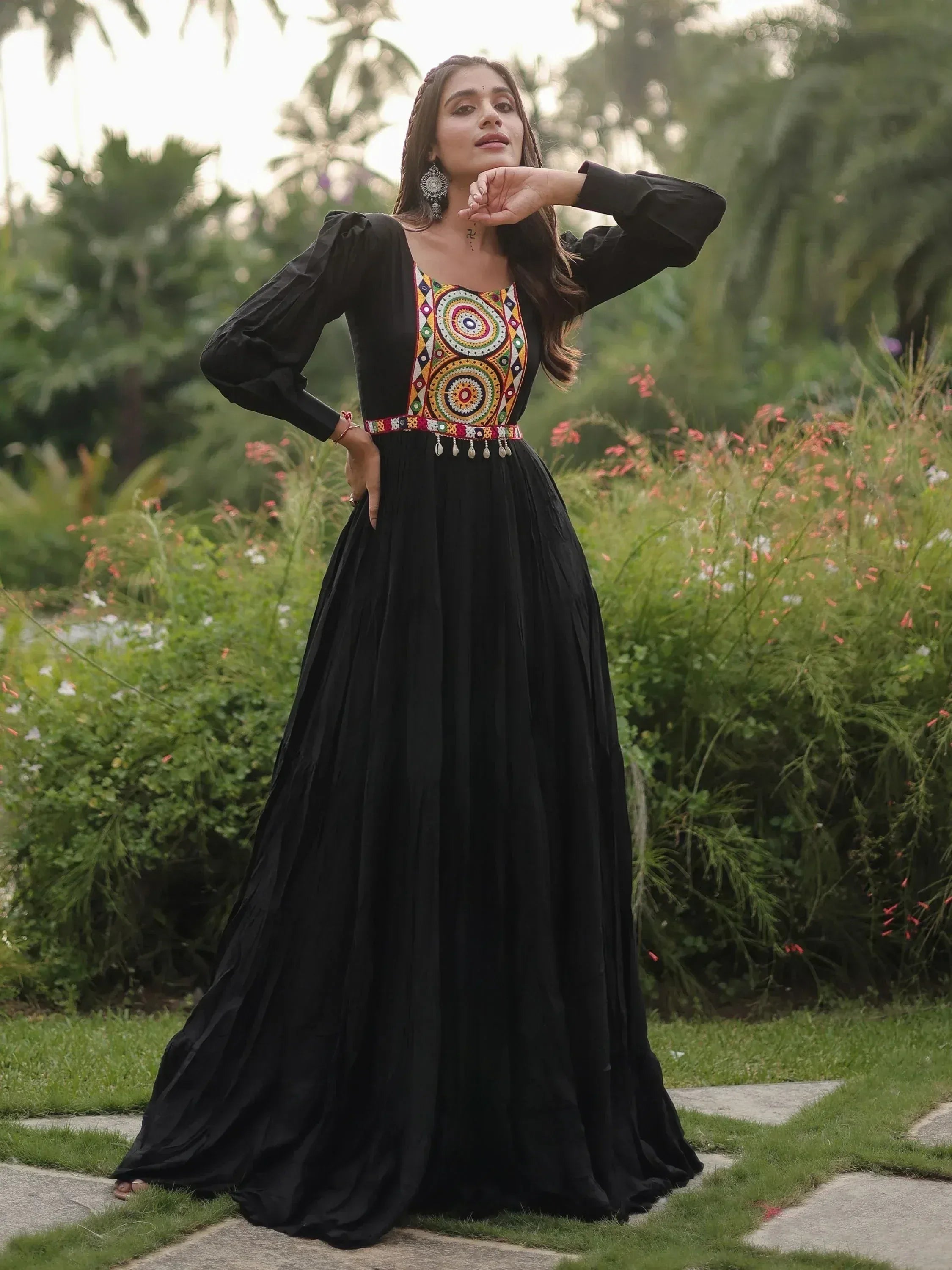 Black ethnic gown with colorful mirror work, long sleeves, and pleated skirt, perfect for Indian occasions.
