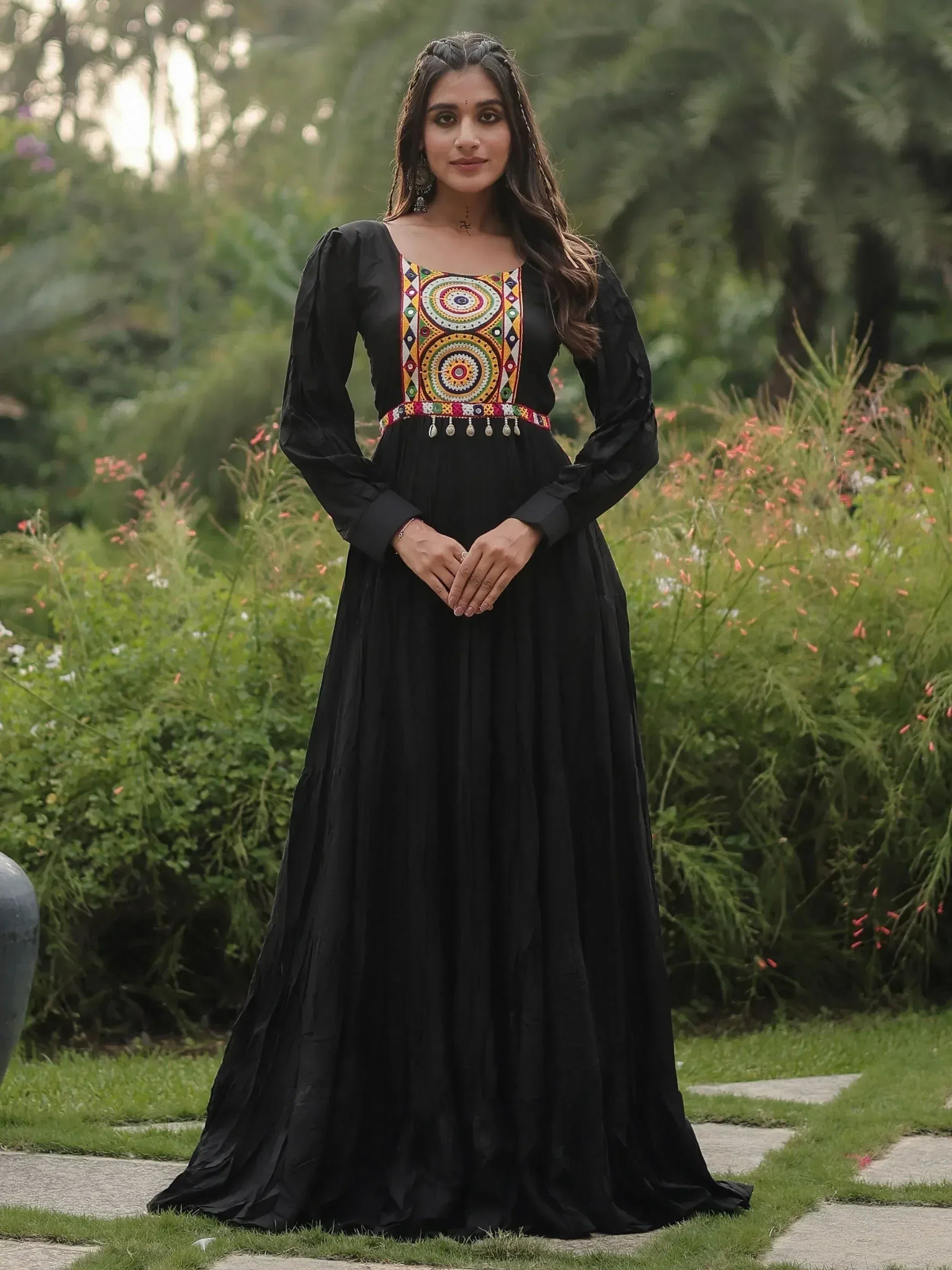 Black ethnic gown with colorful mirror work and long sleeves, perfect for Indian occasions.