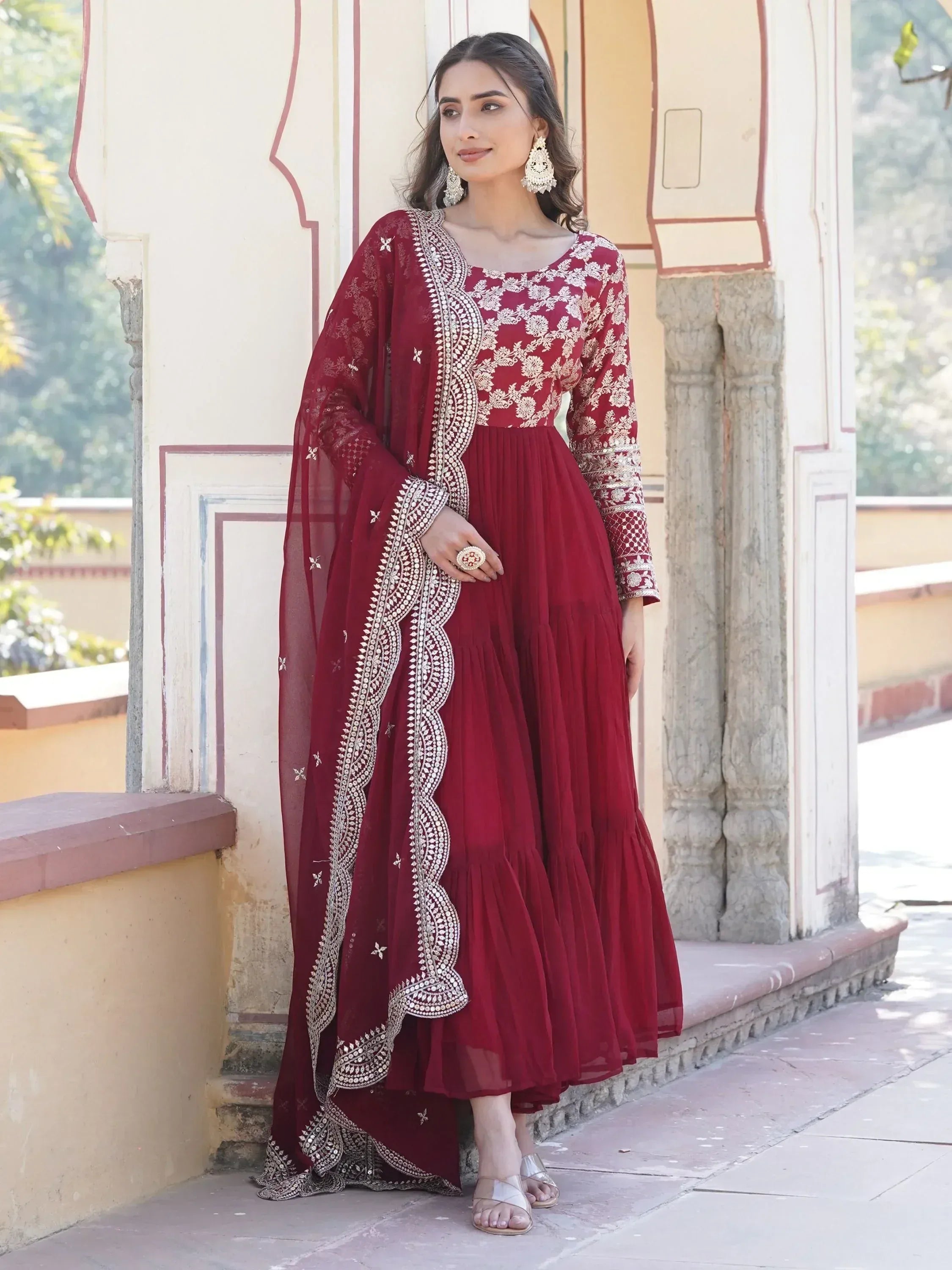 Woman in maroon embroidered Anarkali gown with dupatta, traditional ethnic wear