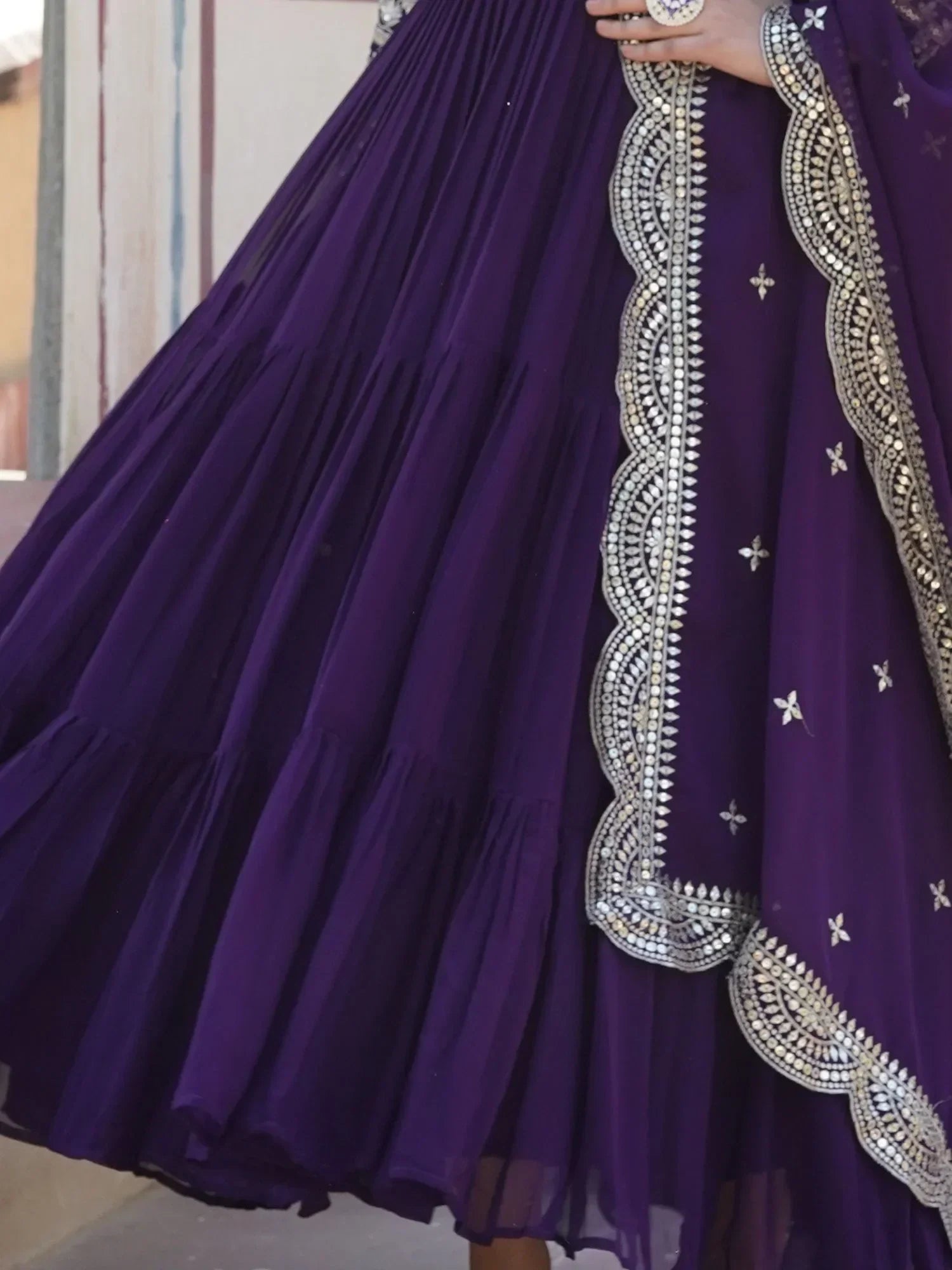 Purple lehenga choli with silver mirror work border and floral embroidery details