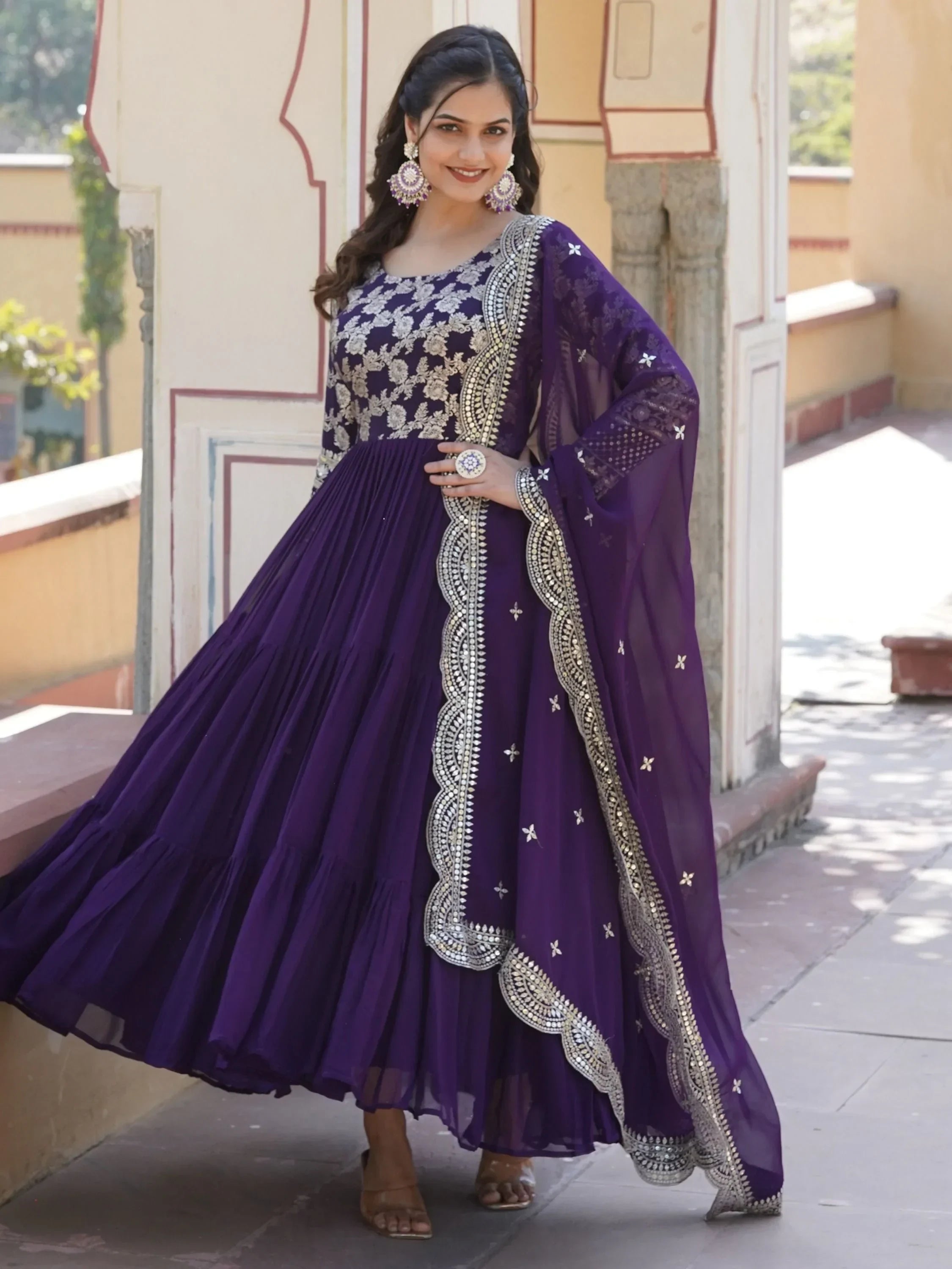 Woman in a purple embroidered Anarkali gown with dupatta, traditional Indian ethnic wear