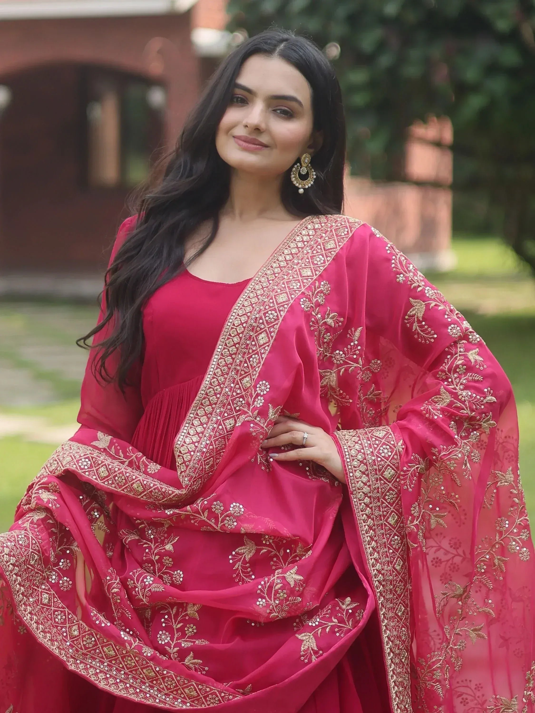 Pink embroidered Indian ethnic gown with gold floral detailing, perfect for festive occasions