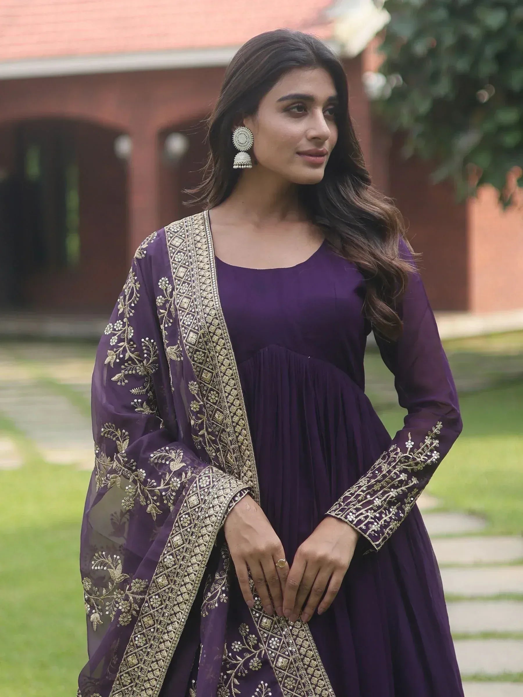 Purple ethnic gown with gold embroidery, perfect for Indian occasions and festive wear.