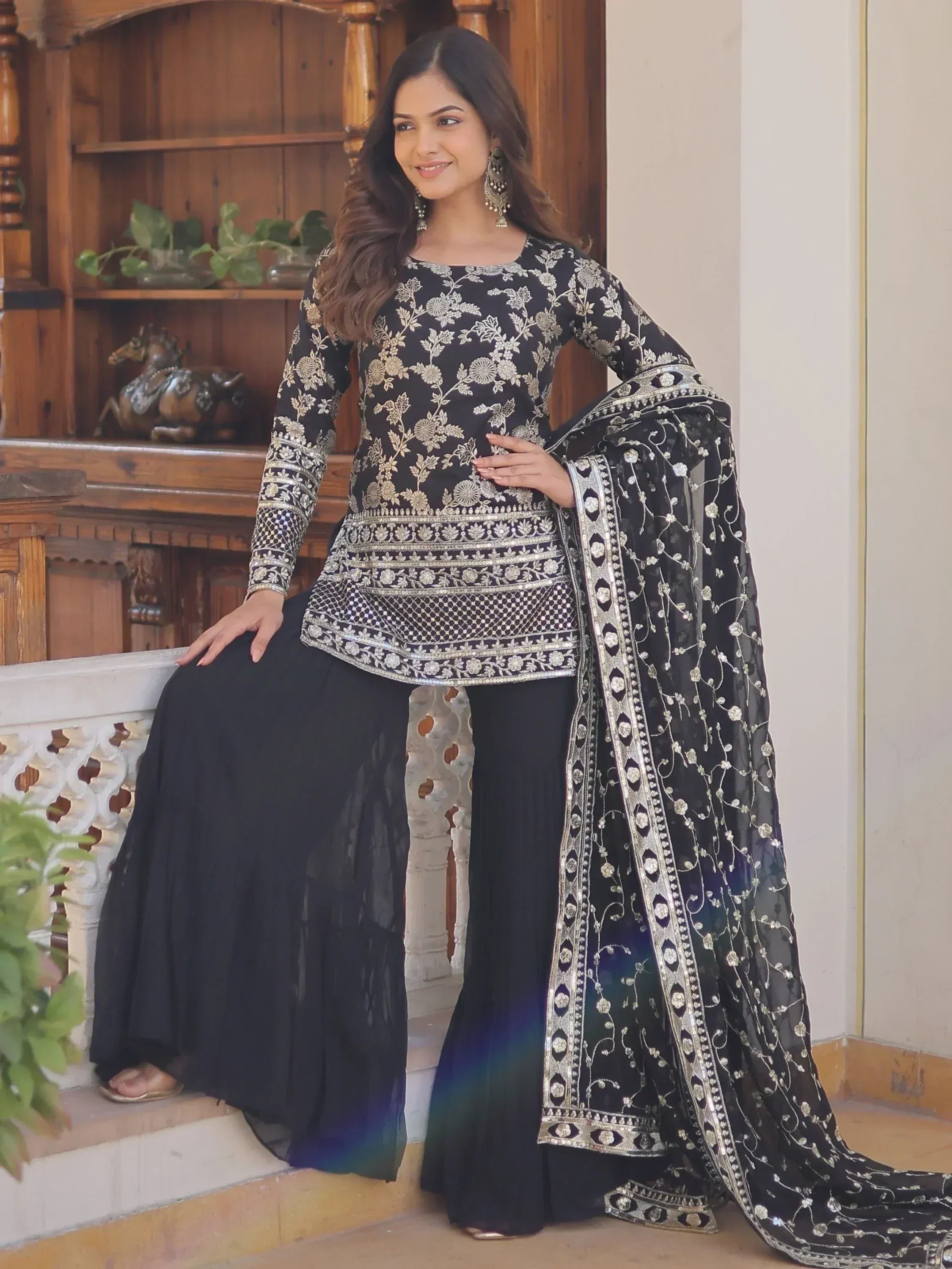 Black embroidered salwar kameez with floral designs and matching dupatta for ethnic wear