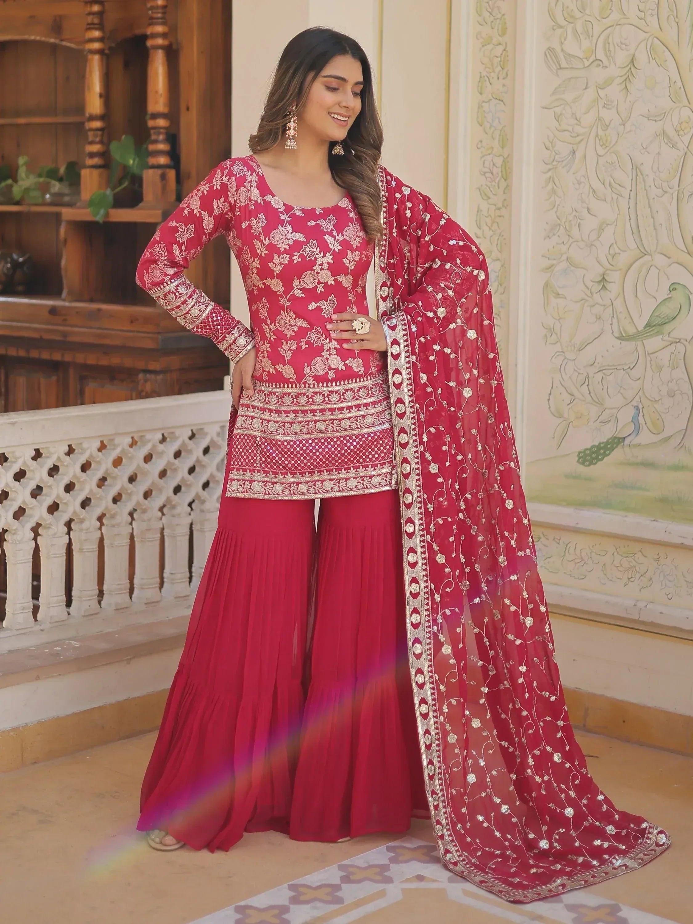 Elegant red embroidered salwar kameez with floral detailing and matching dupatta, perfect for ethnic occasions.