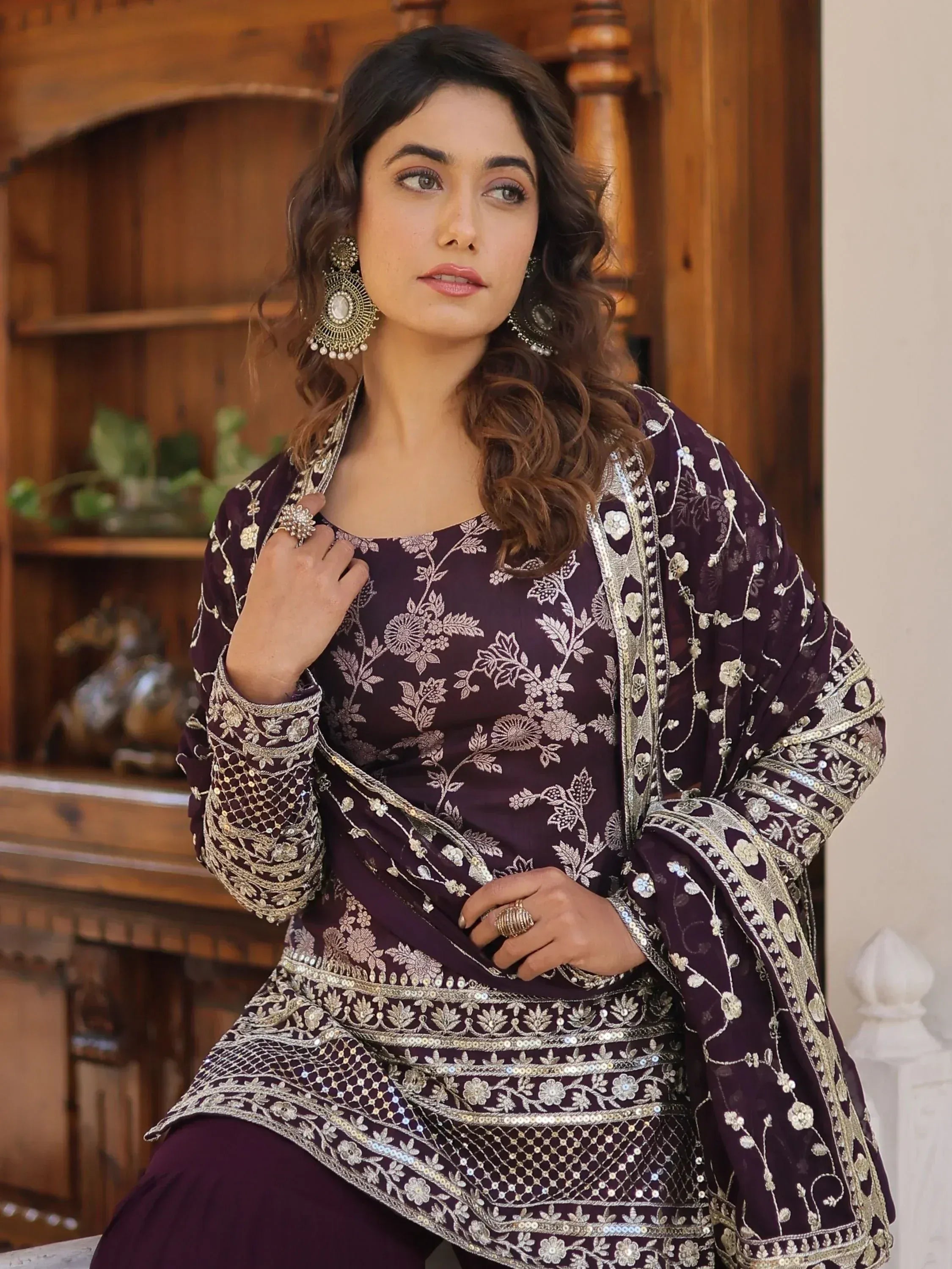 Elegant purple embroidered salwar kameez with gold floral detailing, perfect for festive occasions.