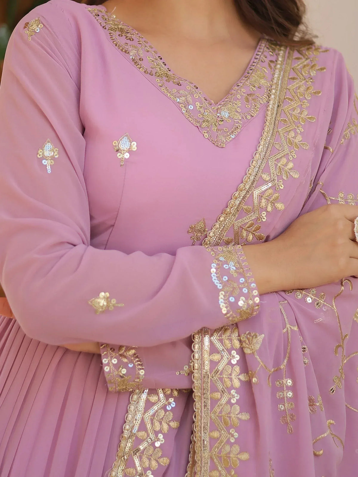 Pink ethnic gown with gold embroidery and sequin detailing, perfect for Indian festive wear