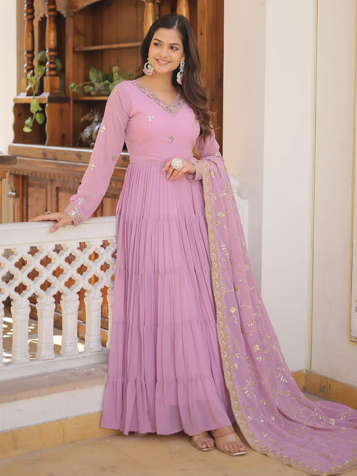 Lavender ethnic gown with gold embroidery, pleated skirt, and matching dupatta for Indian occasions