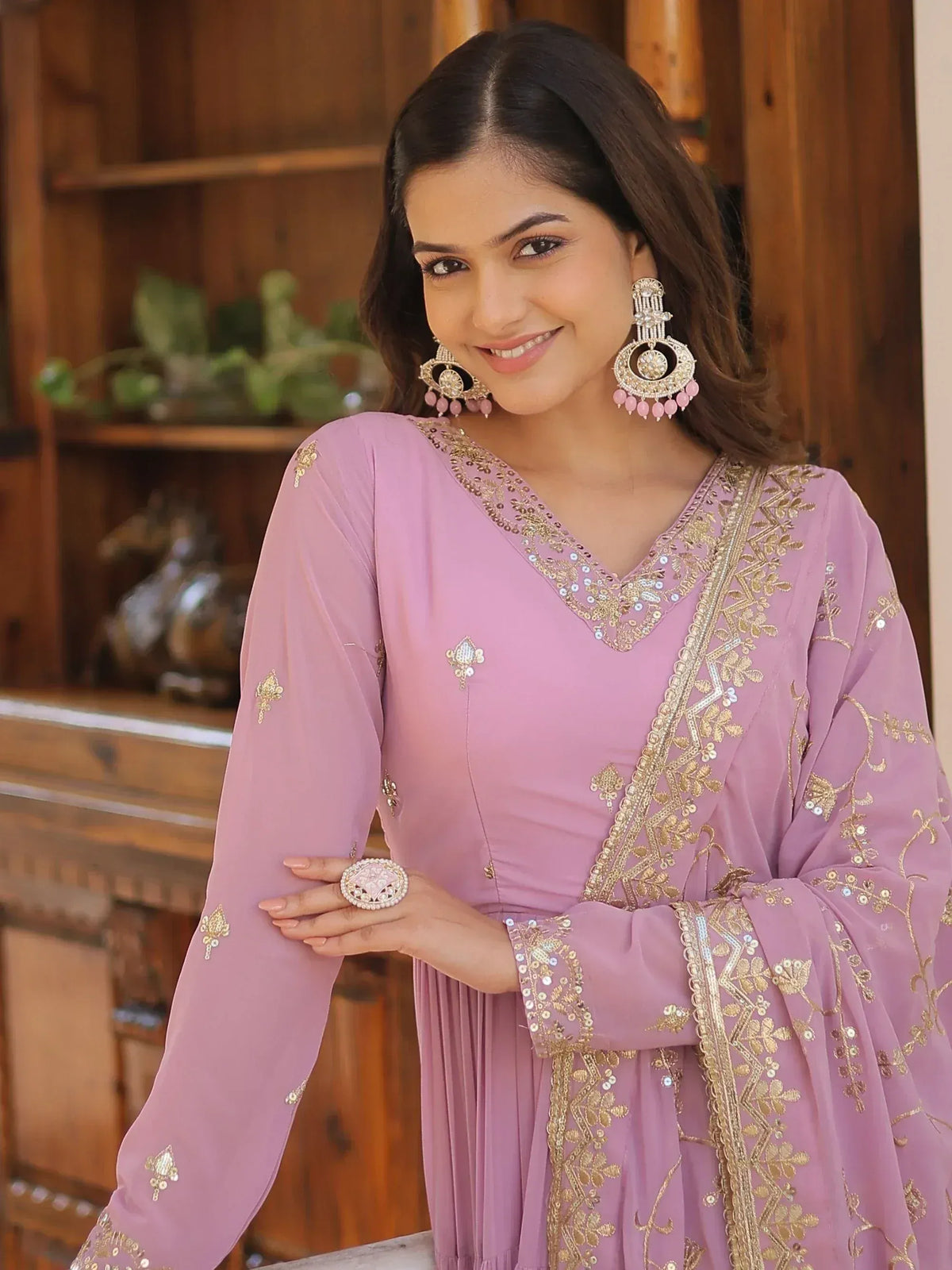Pink embroidered ethnic gown with gold detailing, perfect for Indian occasions and festive wear.