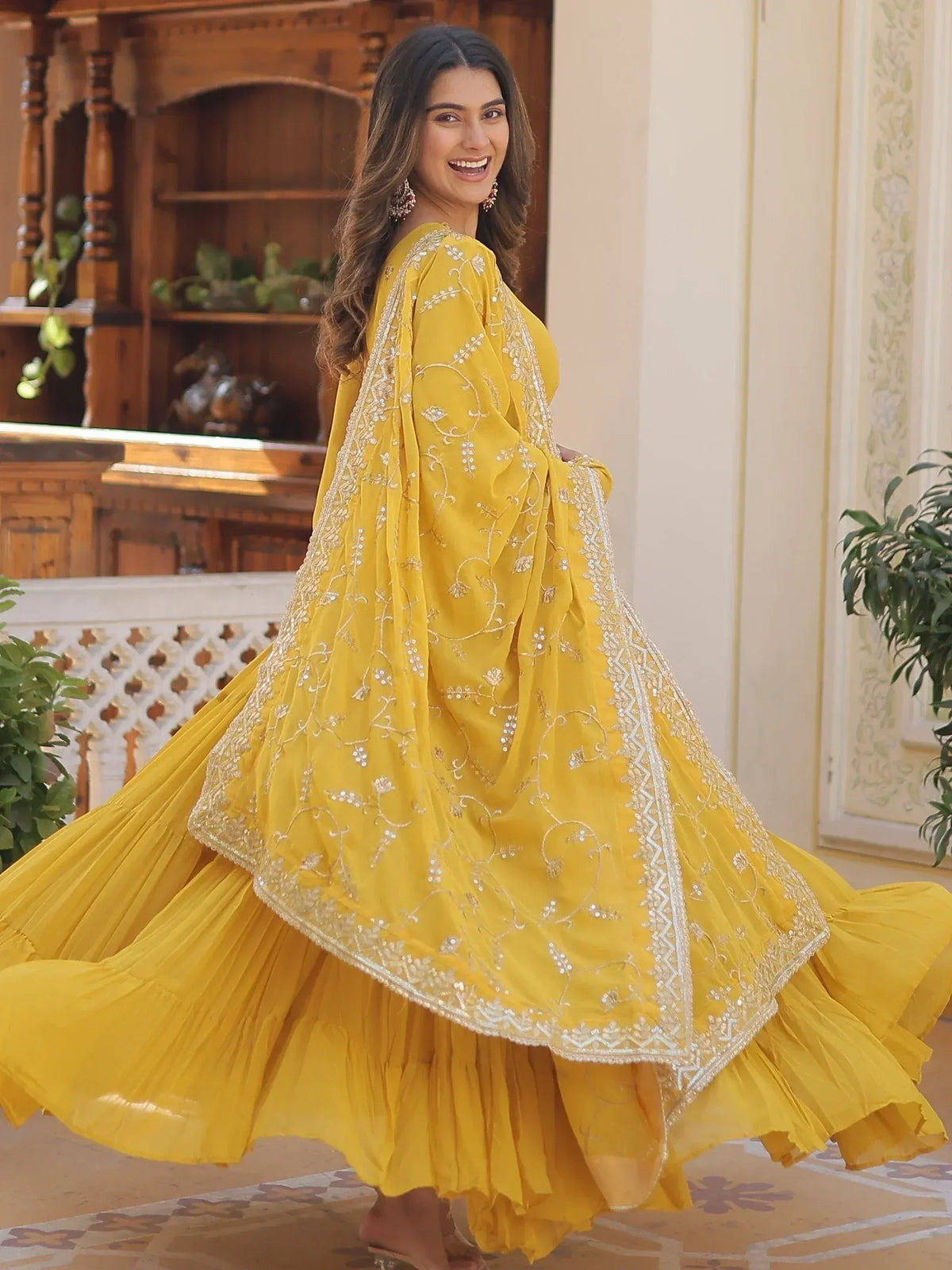 Yellow embroidered ethnic gown with flared skirt, perfect for Indian occasions and festive wear.