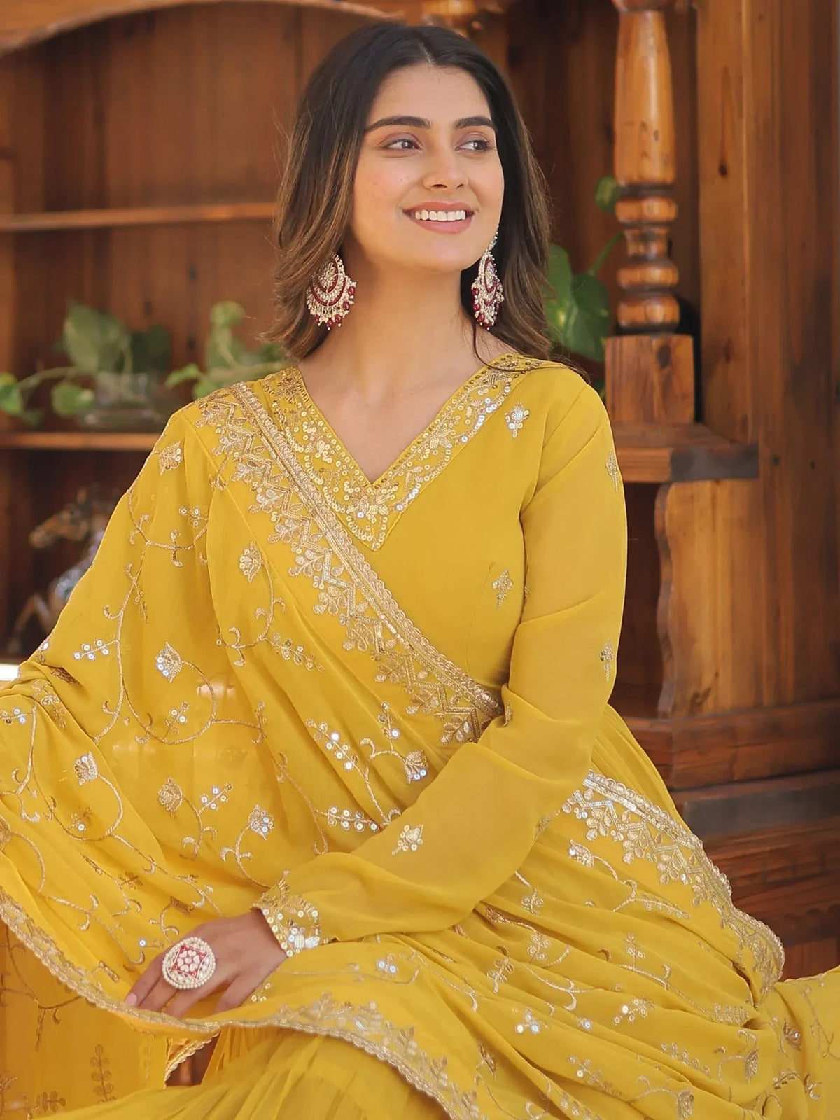 Yellow embroidered ethnic gown with gold detailing, perfect for Indian festive wear and celebrations.
