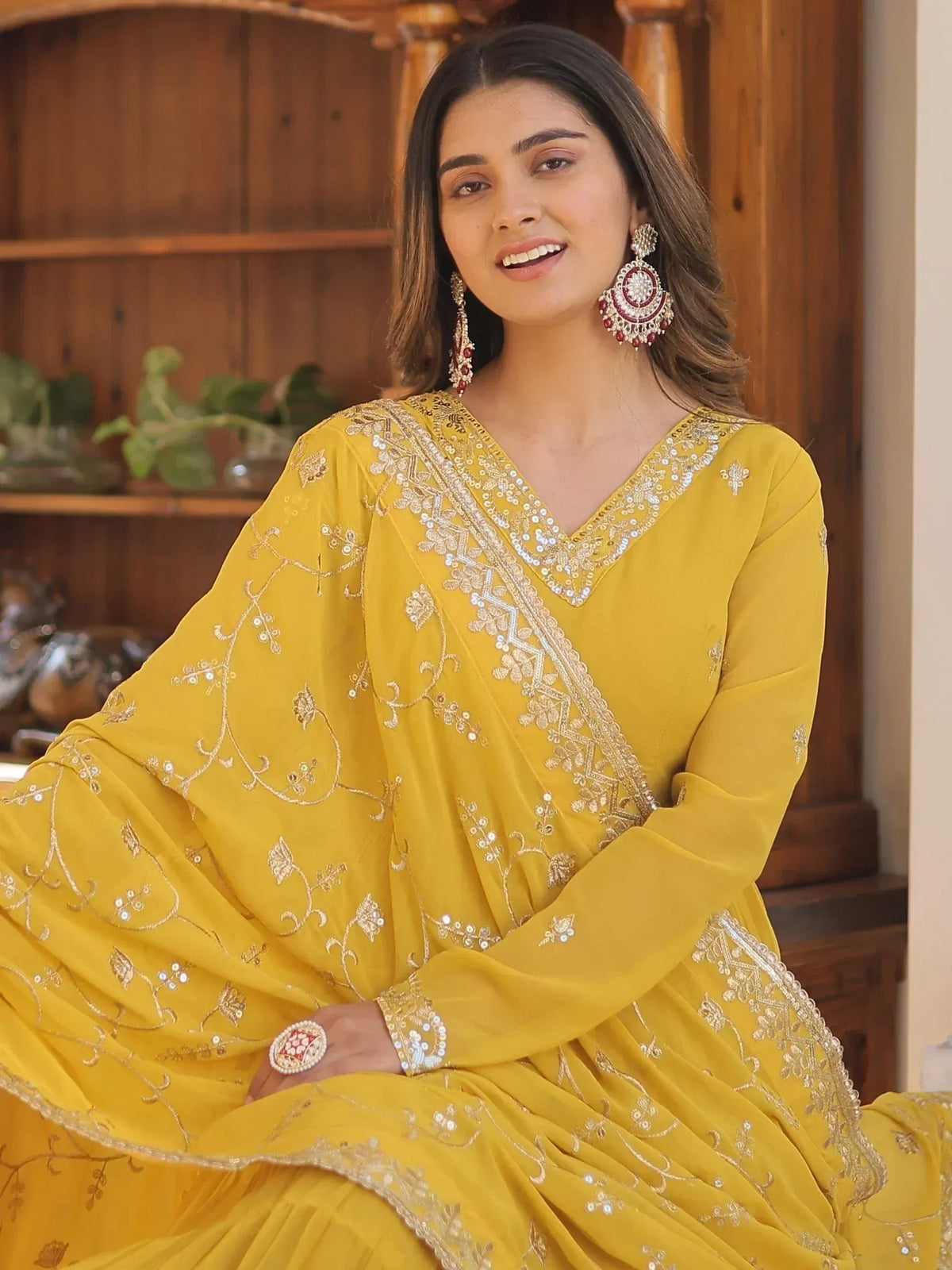 Yellow embroidered ethnic gown with gold detailing, perfect for Indian occasions and festive wear.