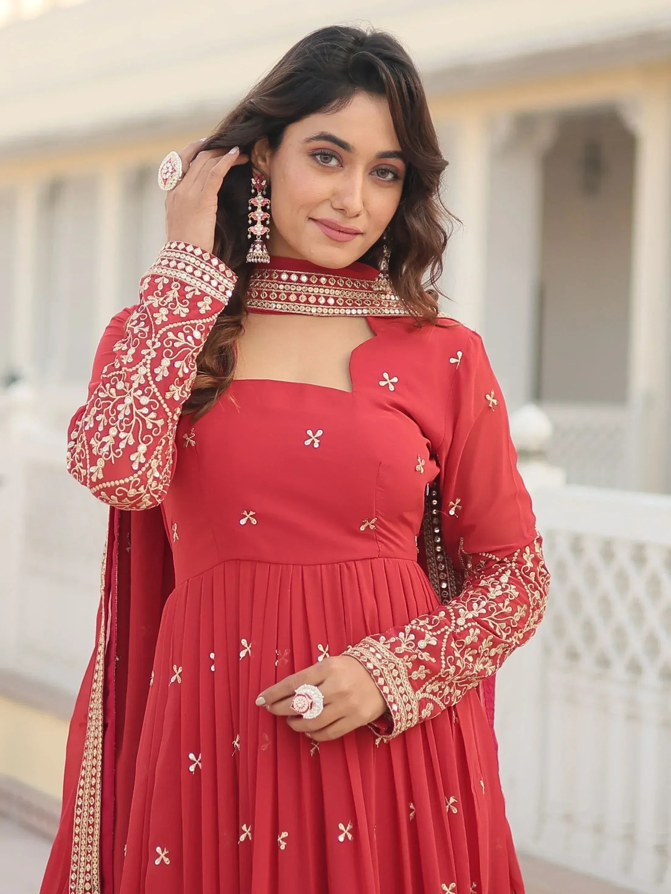 Red embroidered ethnic gown with choker neckline, perfect for Indian weddings or festive occasions