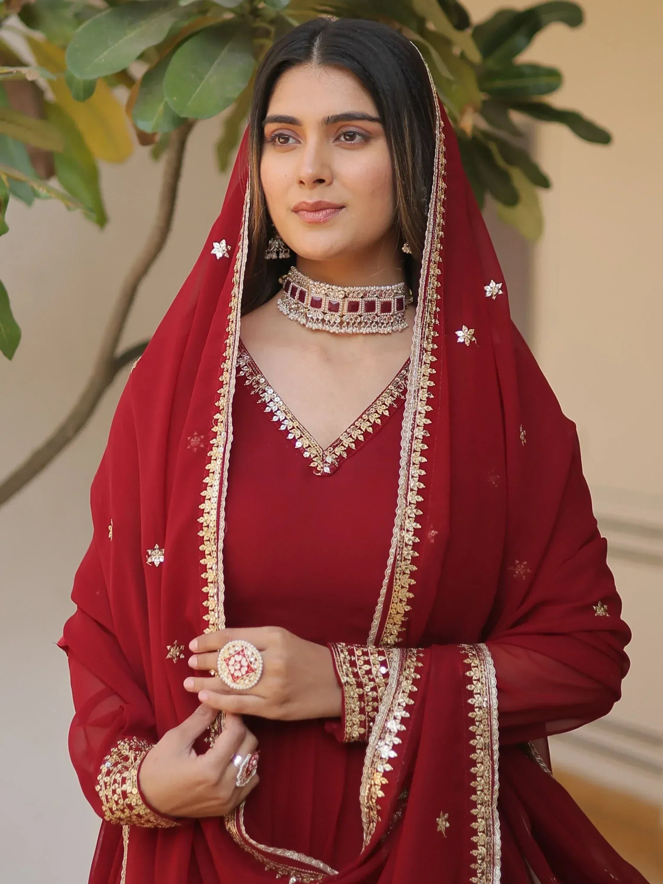 Maroon ethnic salwar kameez with gold embroidery and matching dupatta, perfect for Indian weddings and festive occasions.