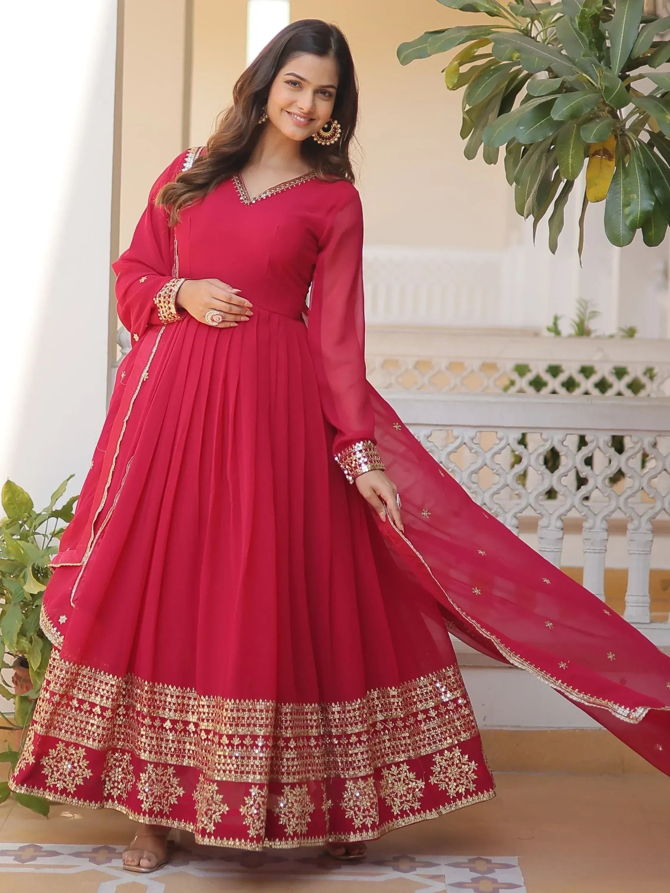 Red ethnic anarkali gown with gold embroidery, perfect for Indian weddings and festive occasions