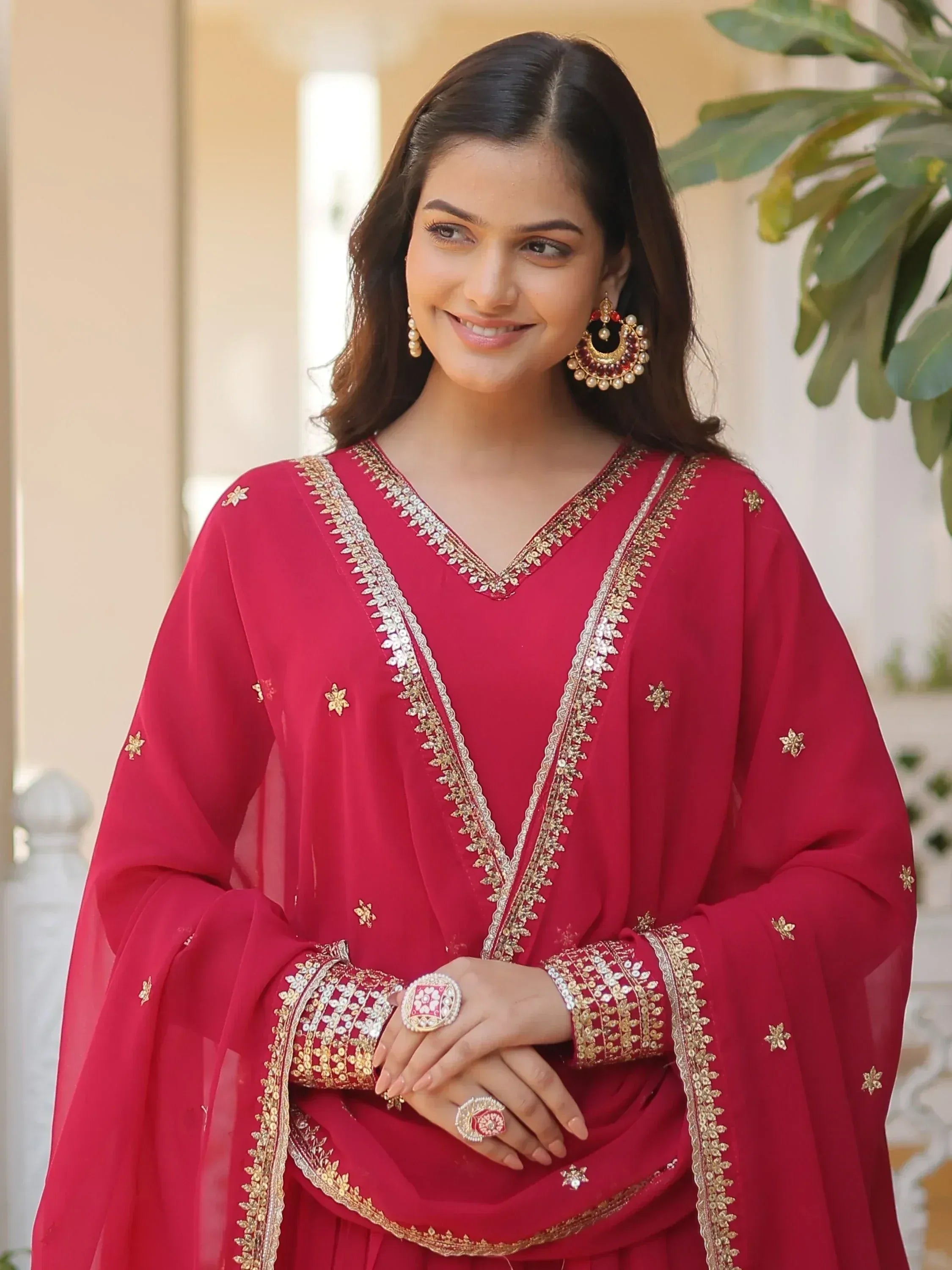 Red ethnic salwar kameez with gold embroidery and traditional jewelry for Indian wear