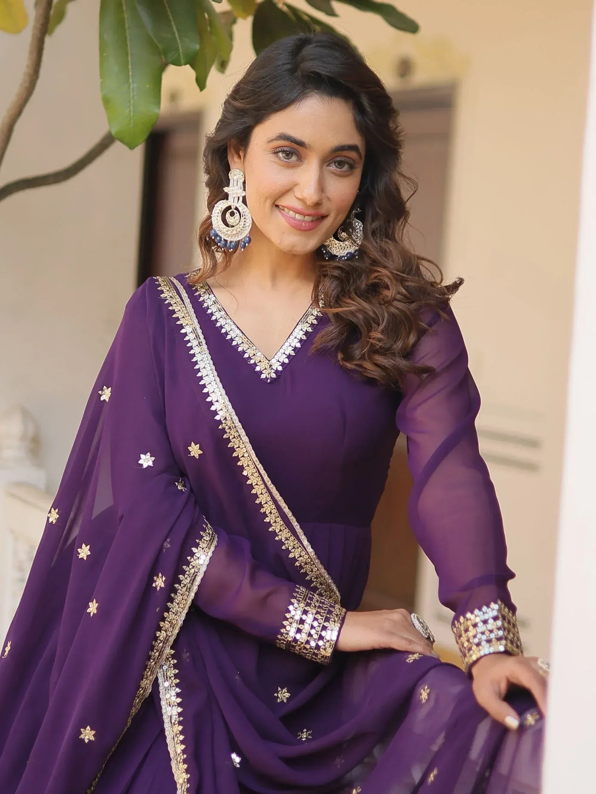 Purple embroidered ethnic gown with gold detailing, perfect for Indian festive occasions