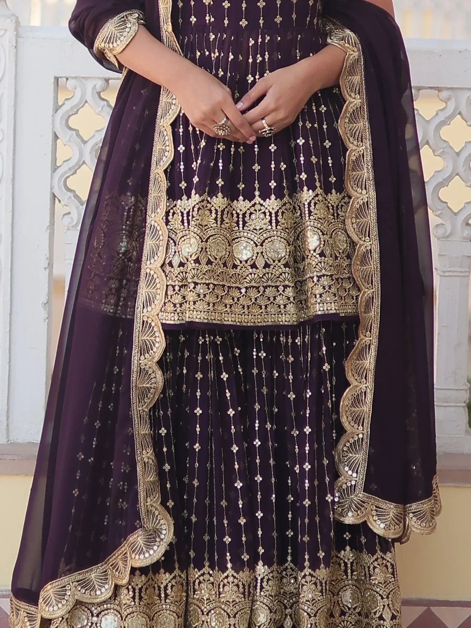 Elegant purple Indian ethnic gown with gold embroidery and scalloped dupatta, perfect for weddings and festivals.