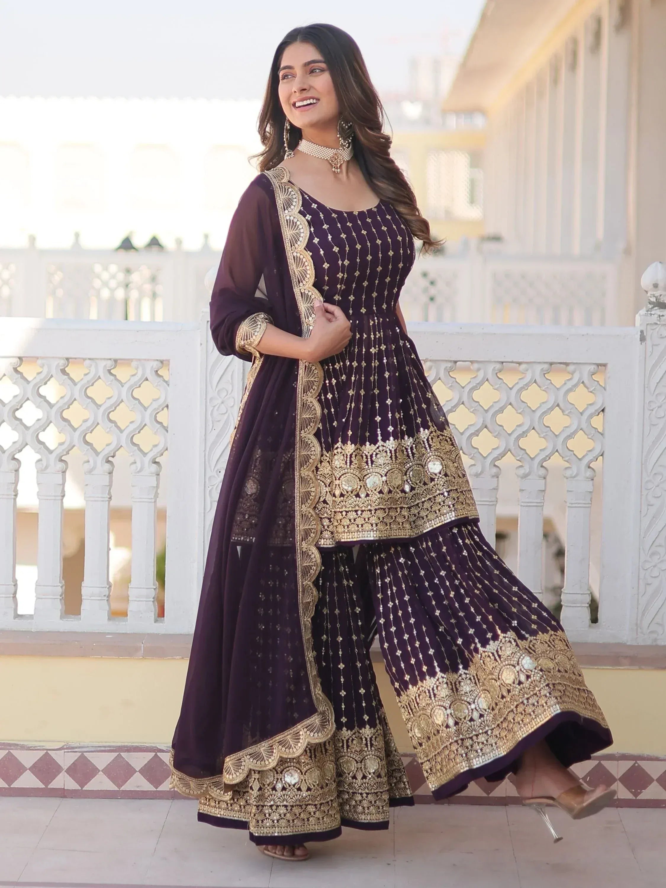 Elegant purple Indian ethnic wear with gold embroidery, perfect for festive occasions and weddings.