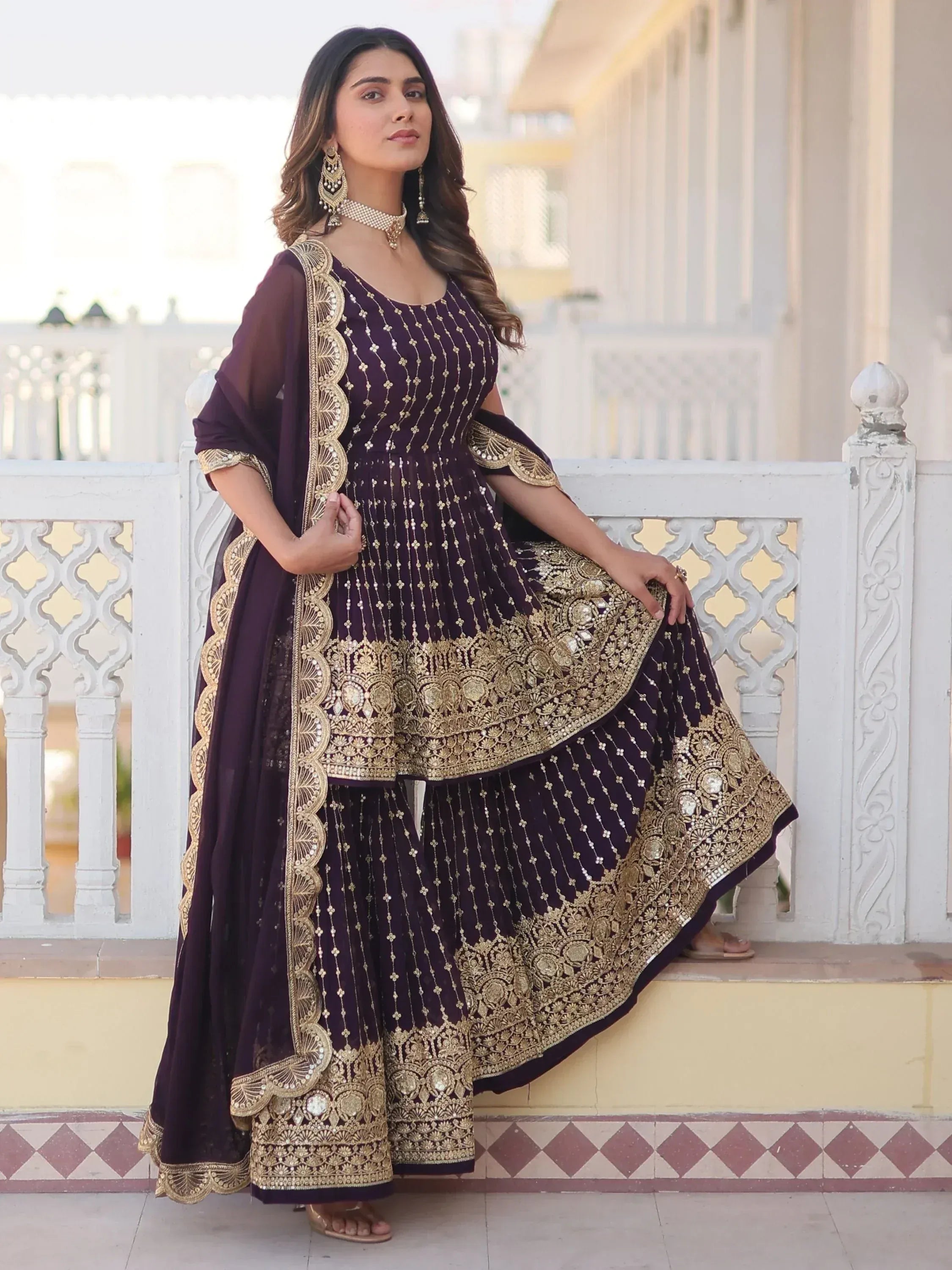 Elegant purple Indian ethnic wear with gold embroidery, perfect for weddings and festive occasions.