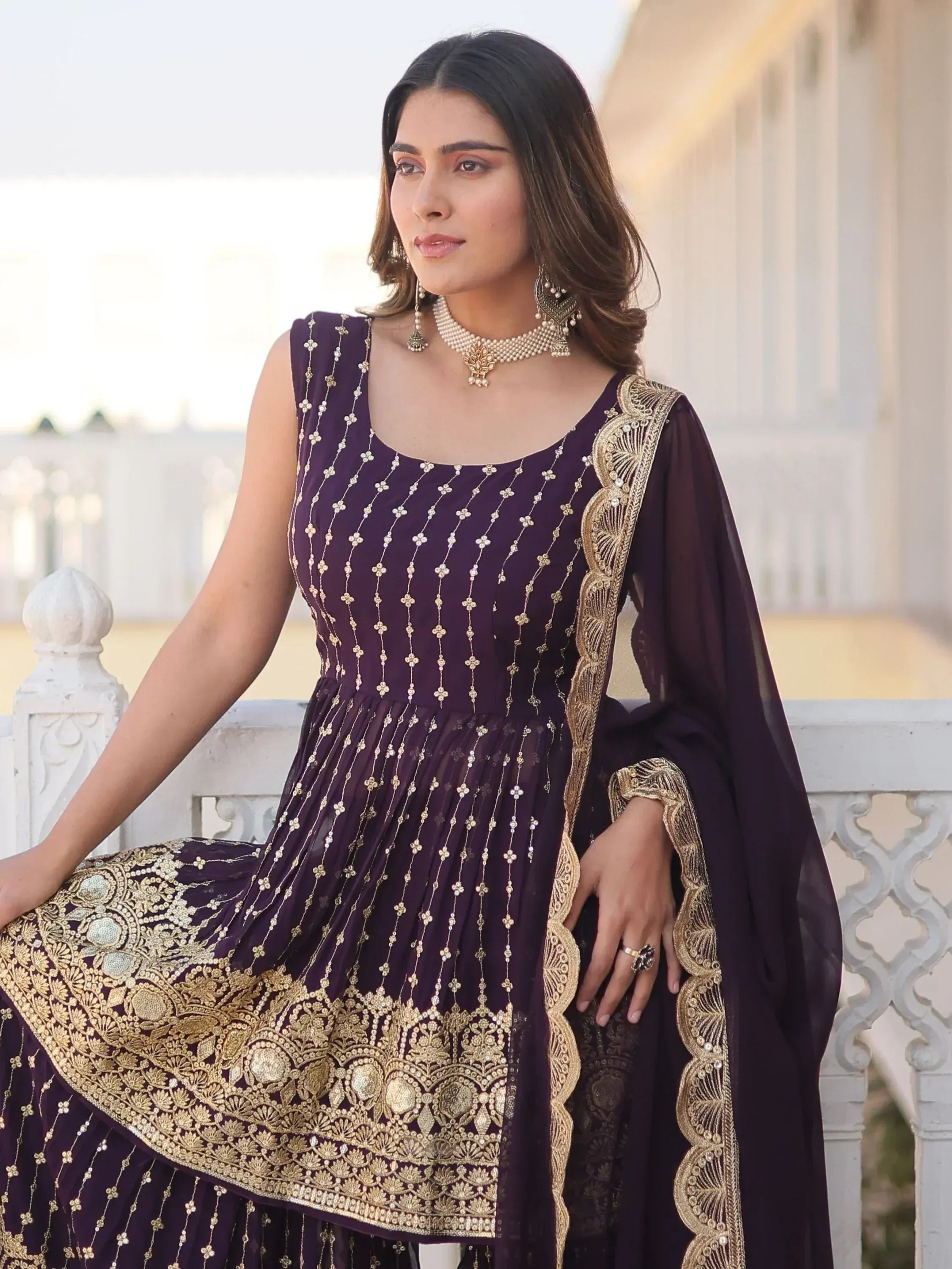 Elegant purple ethnic gown with gold embroidery and matching dupatta, perfect for Indian celebrations.