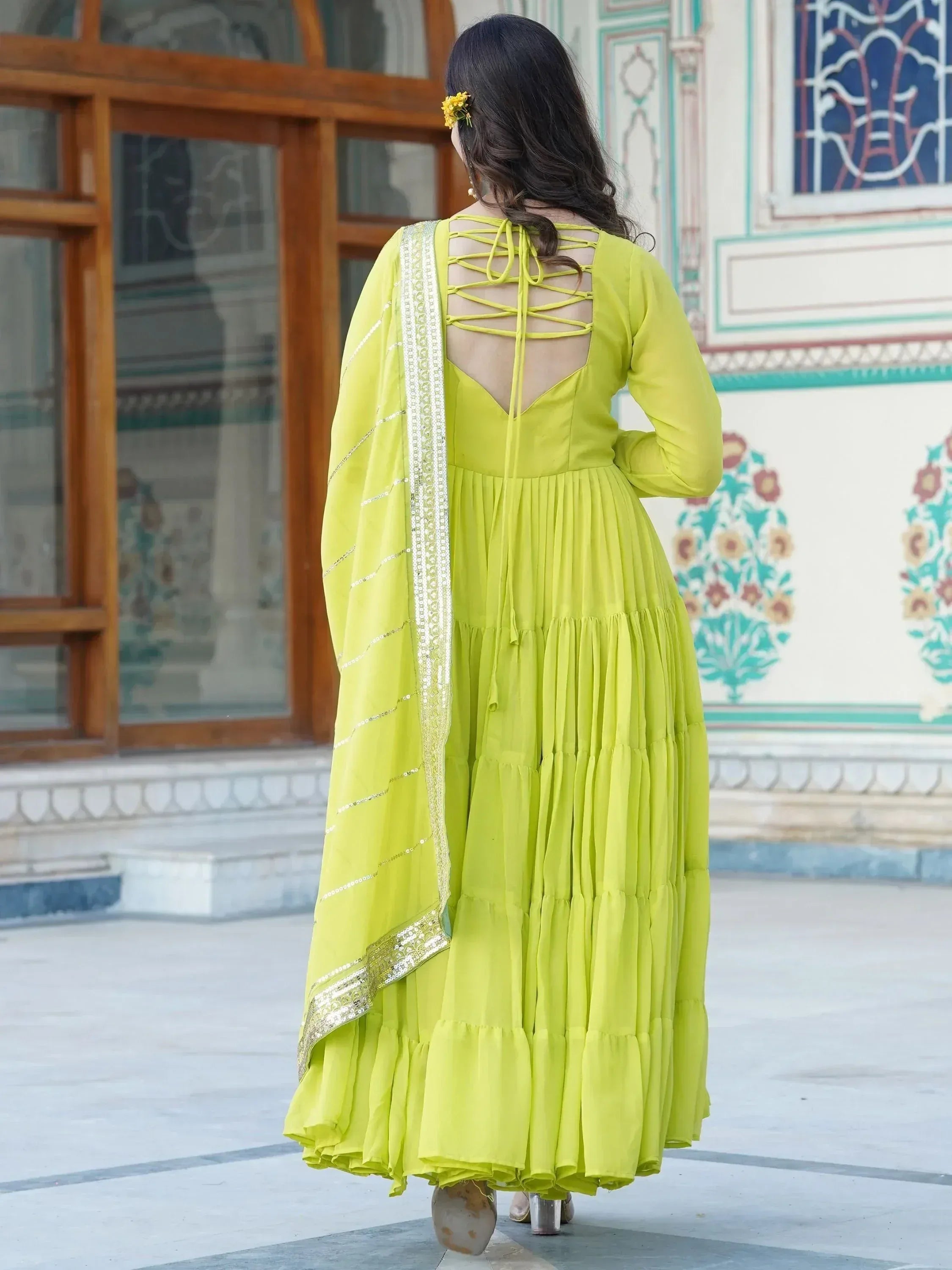 Lime green ethnic gown with crisscross back, pleated skirt, and sequined dupatta for Indian wear