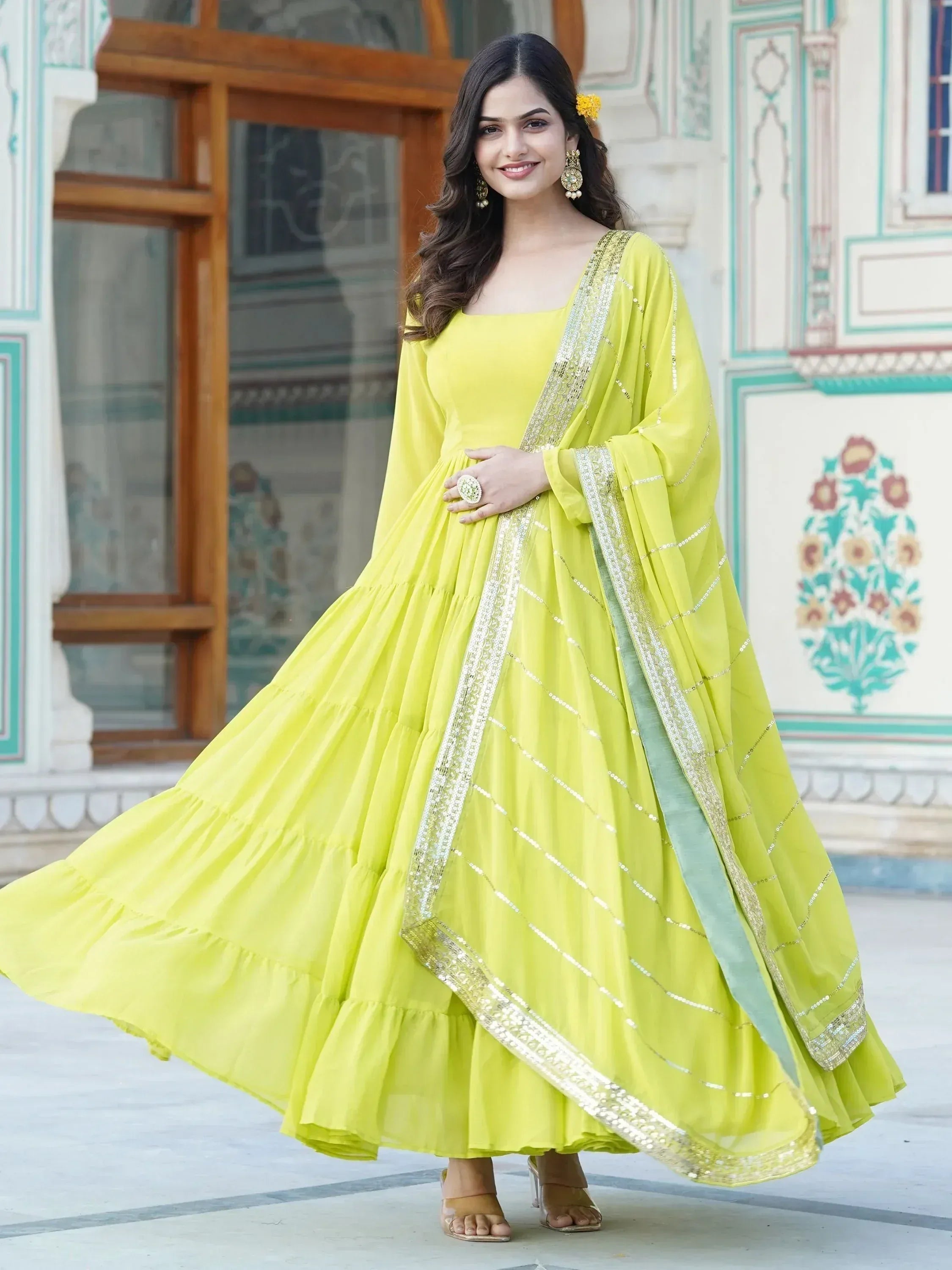 Lemon yellow ethnic gown with gold sequin border, perfect for Indian weddings and festive occasions.