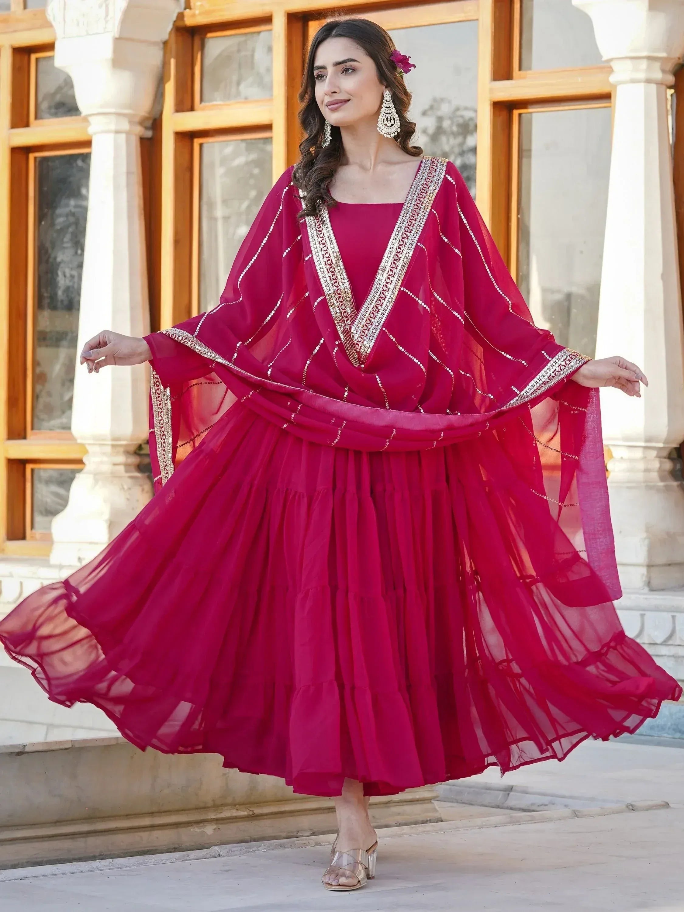Elegant maroon ethnic gown with gold embroidery, perfect for Indian celebrations and festive occasions.