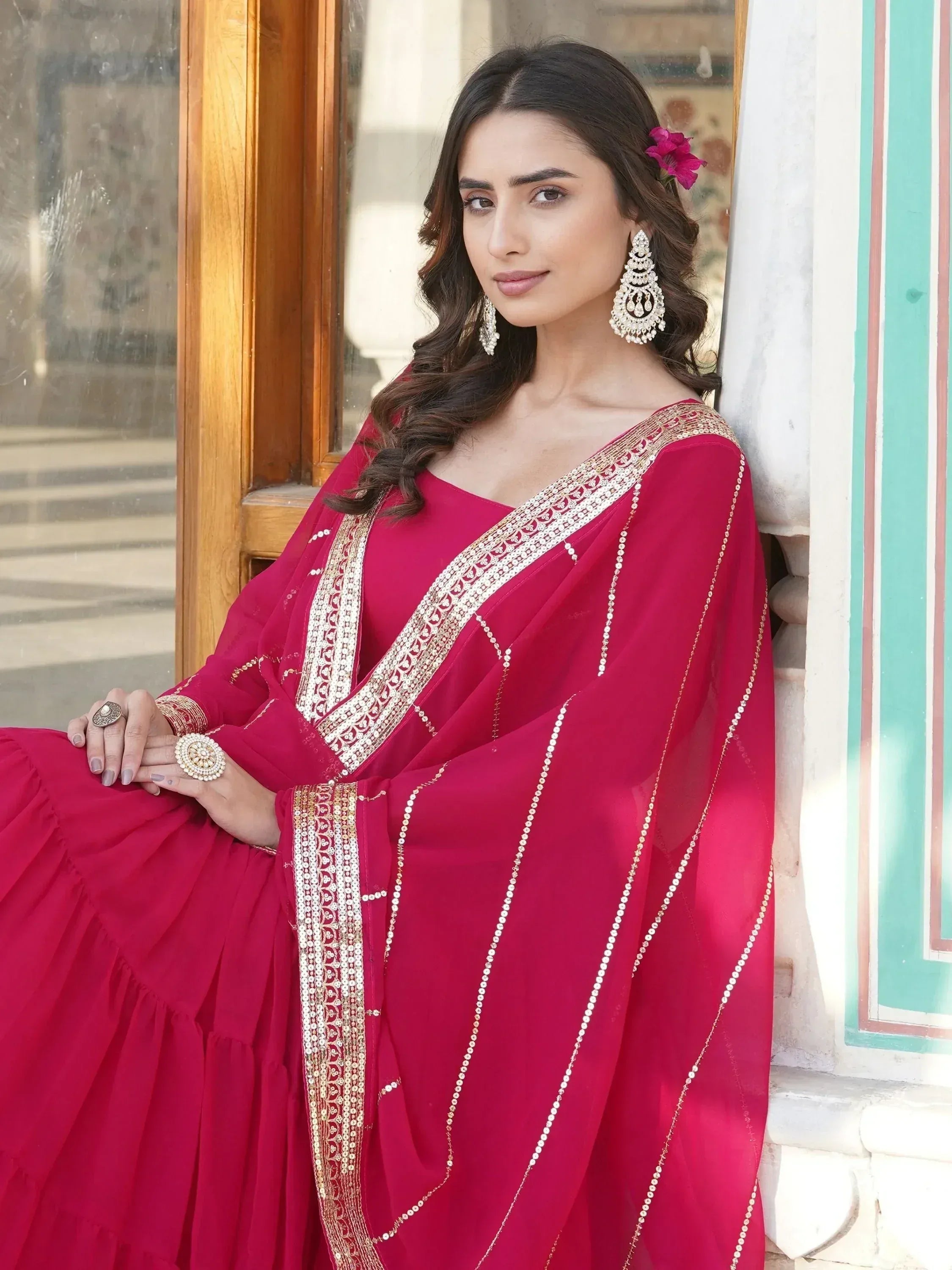 Elegant woman in pink ethnic gown with gold embroidery, perfect for Indian weddings or festive occasions.