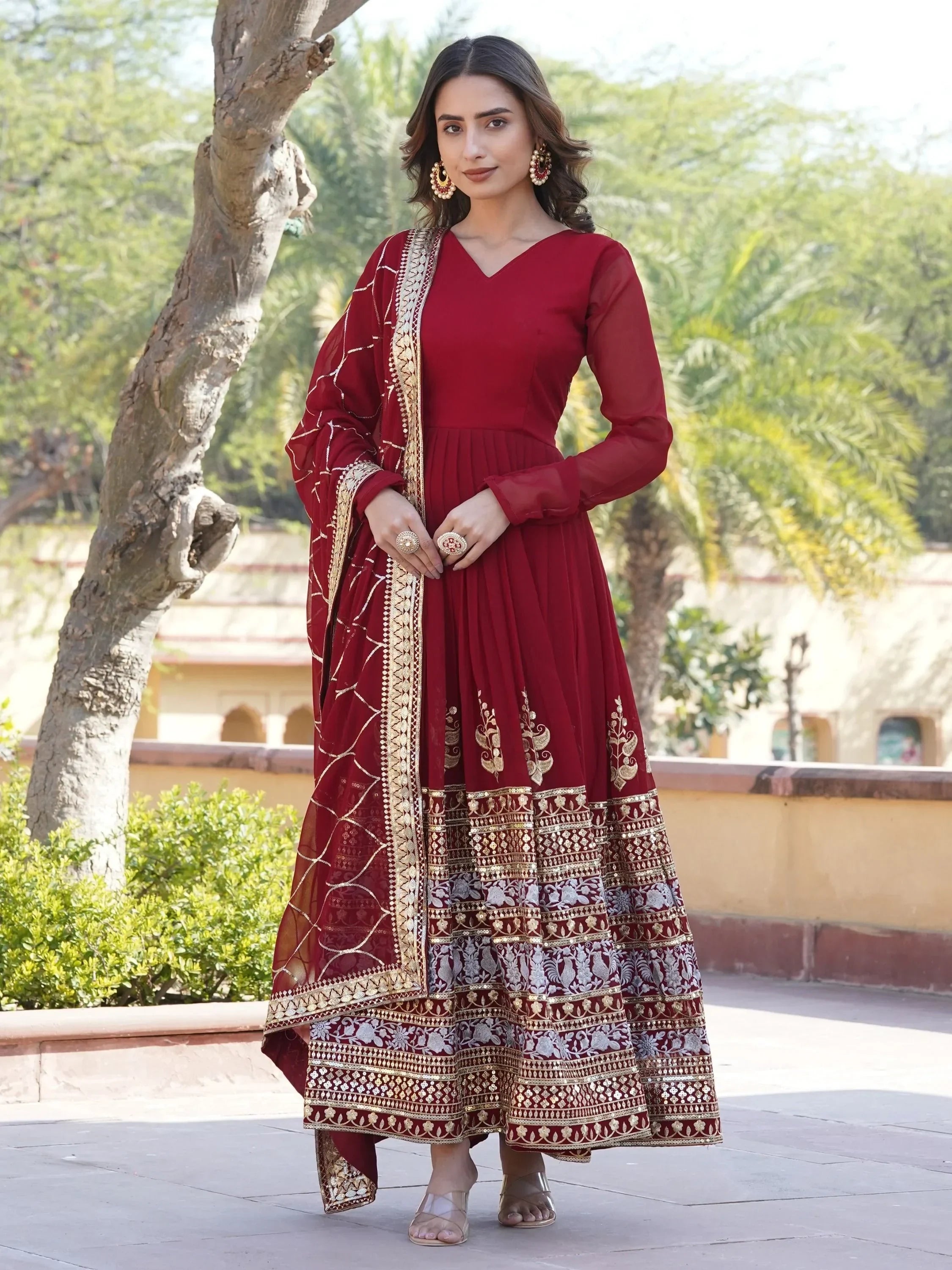 Maroon ethnic anarkali suit with gold embroidery and dupatta, perfect for Indian weddings and festive occasions
