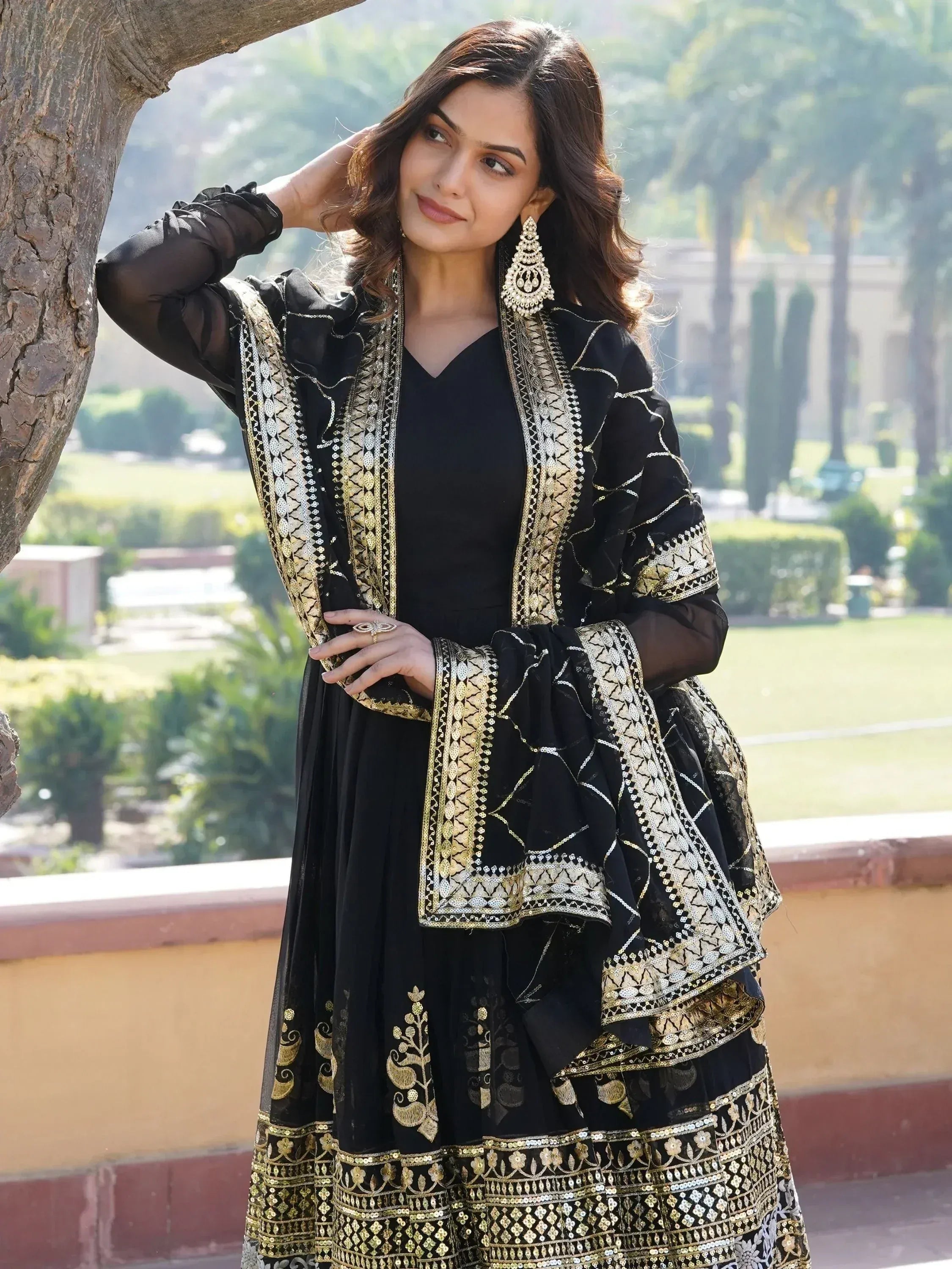 Black and gold embroidered ethnic gown with sheer sleeves, perfect for Indian occasions
