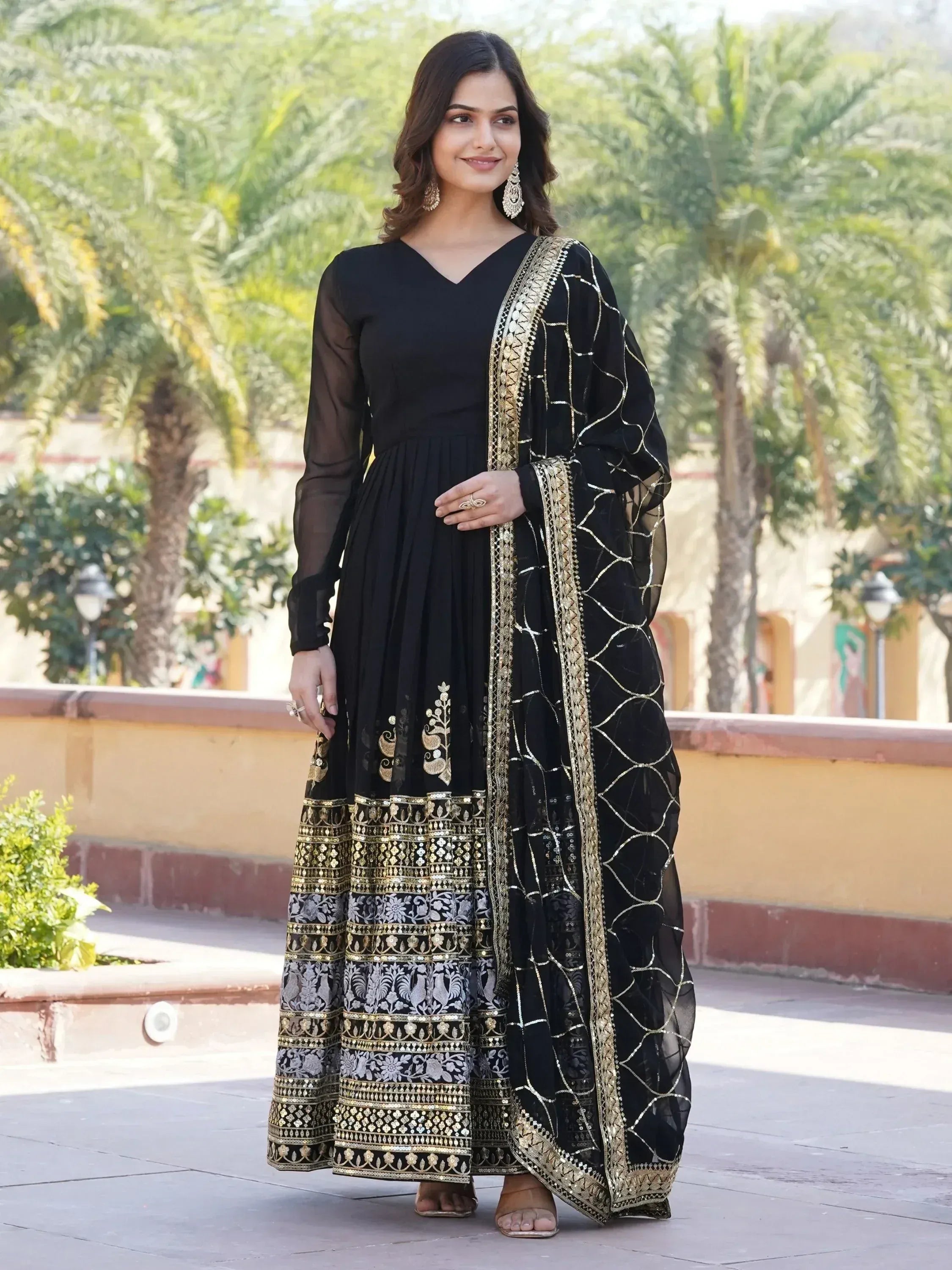 Black ethnic gown with gold embroidery and sheer dupatta, perfect for Indian occasions