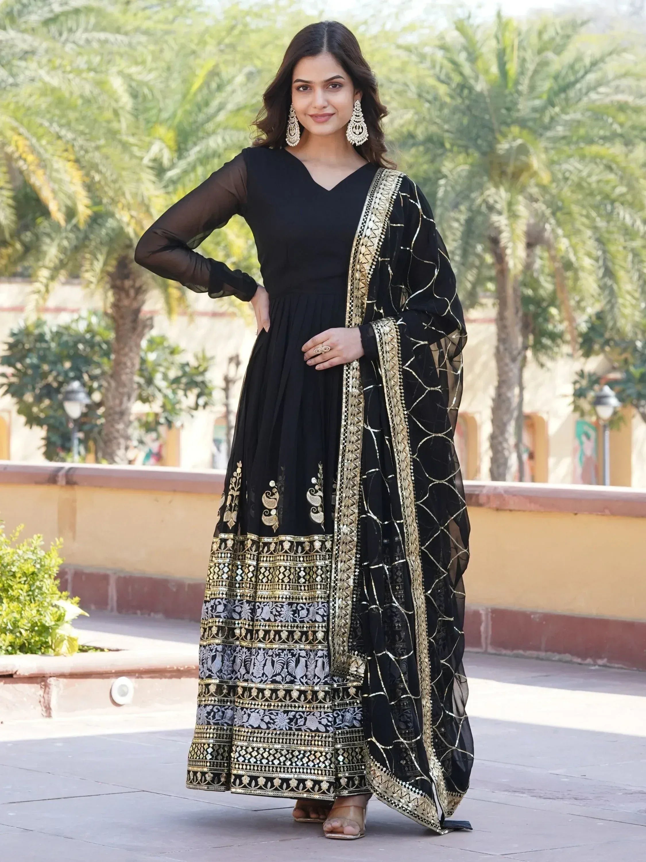Black ethnic gown with gold embroidery and sheer dupatta, perfect for Indian occasions