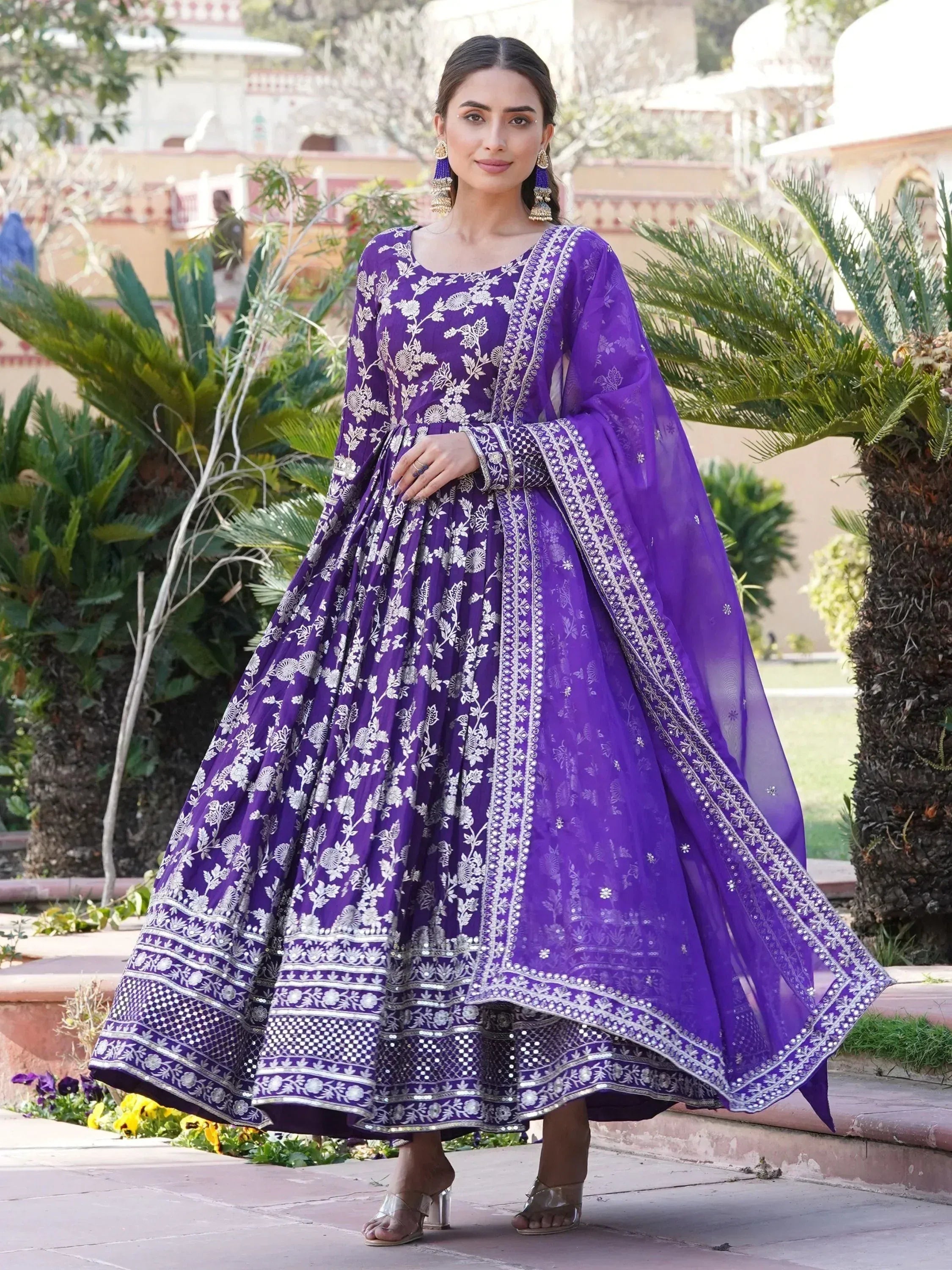 Woman in a purple embroidered Anarkali gown with dupatta, traditional Indian ethnic wear