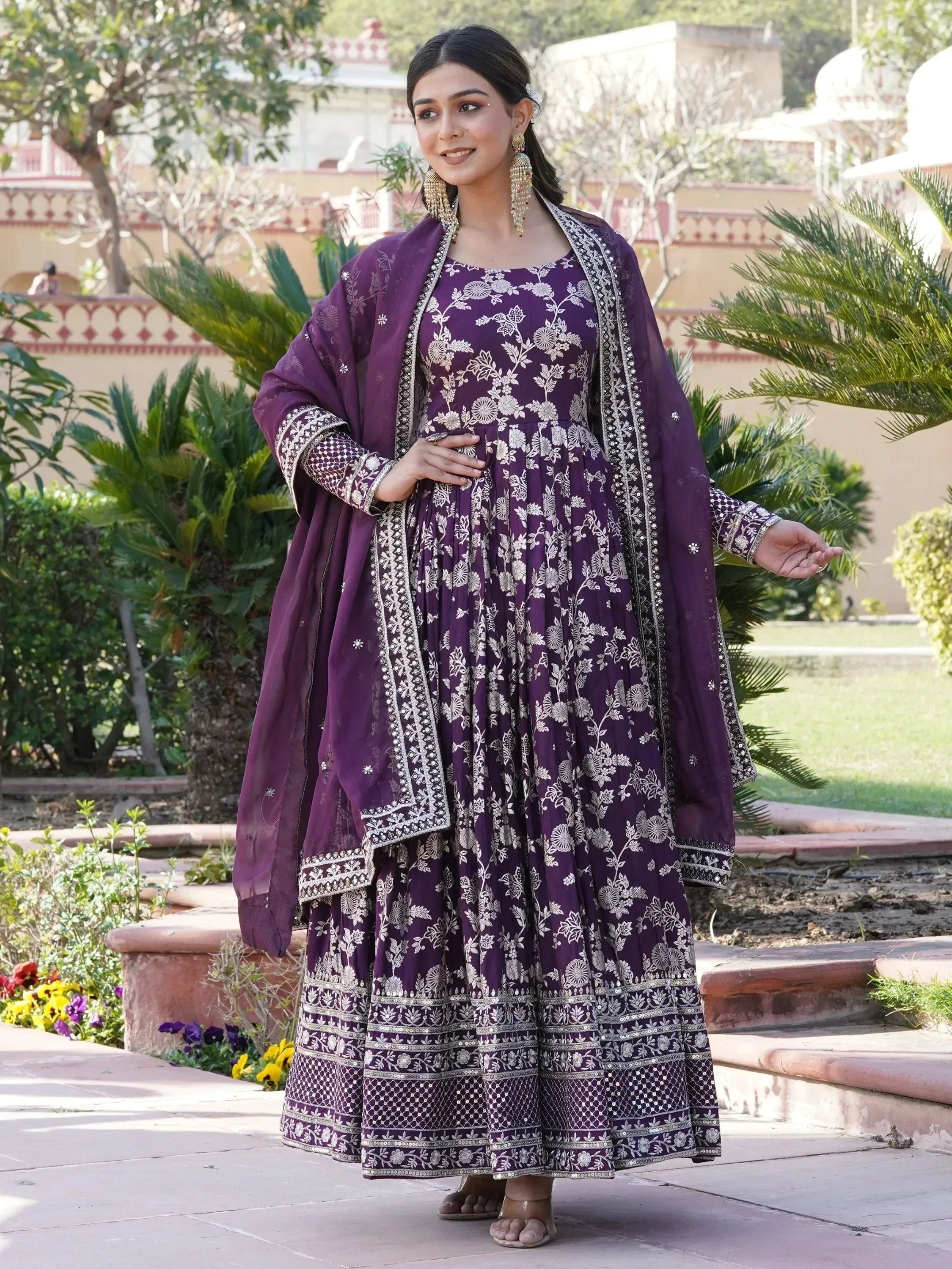 Woman in a purple embroidered Anarkali gown with dupatta, ethnic wear outdoor setting