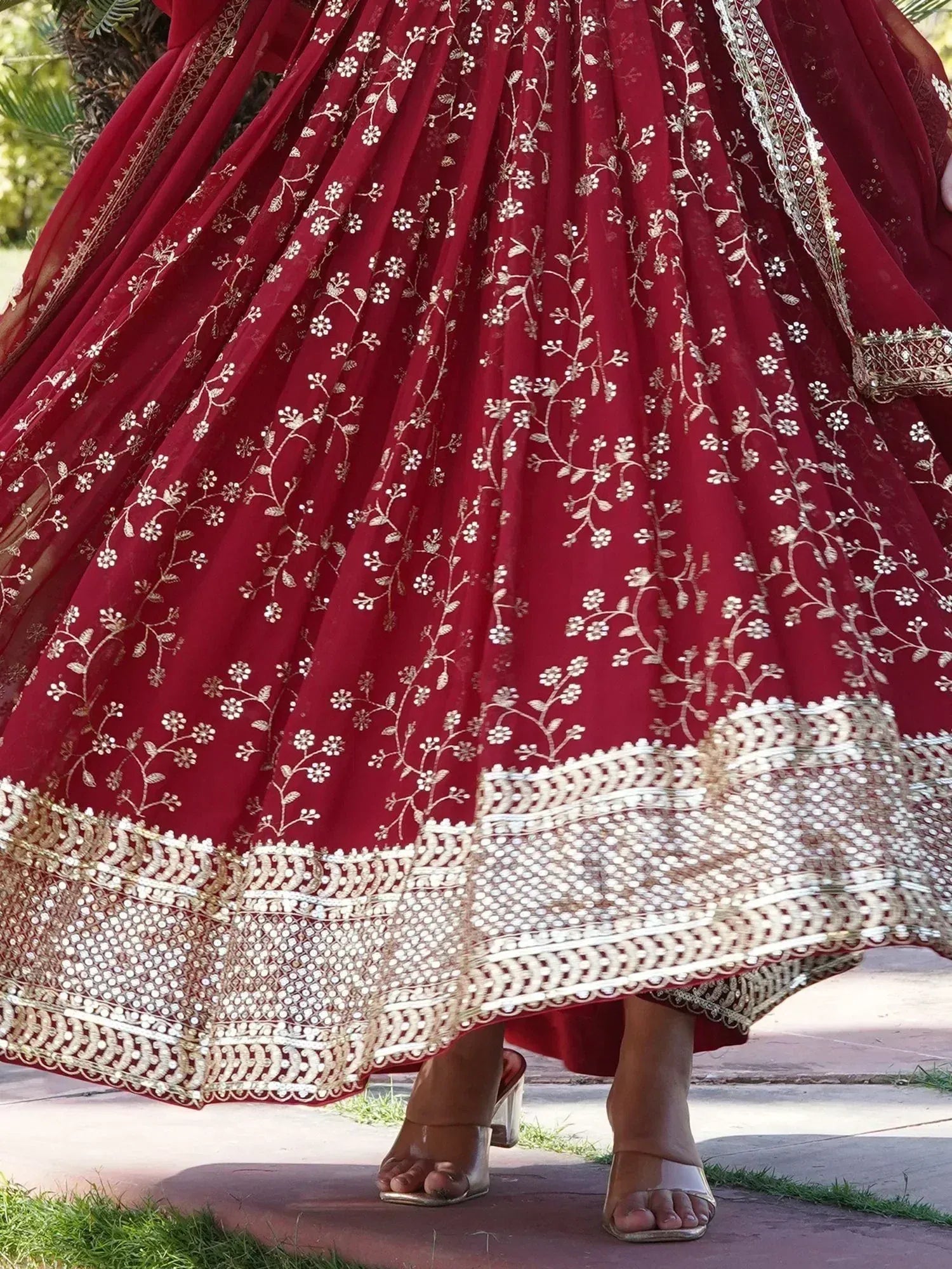 Maroon lehenga with gold floral embroidery and mirror work, perfect for Indian weddings and festive occasions.