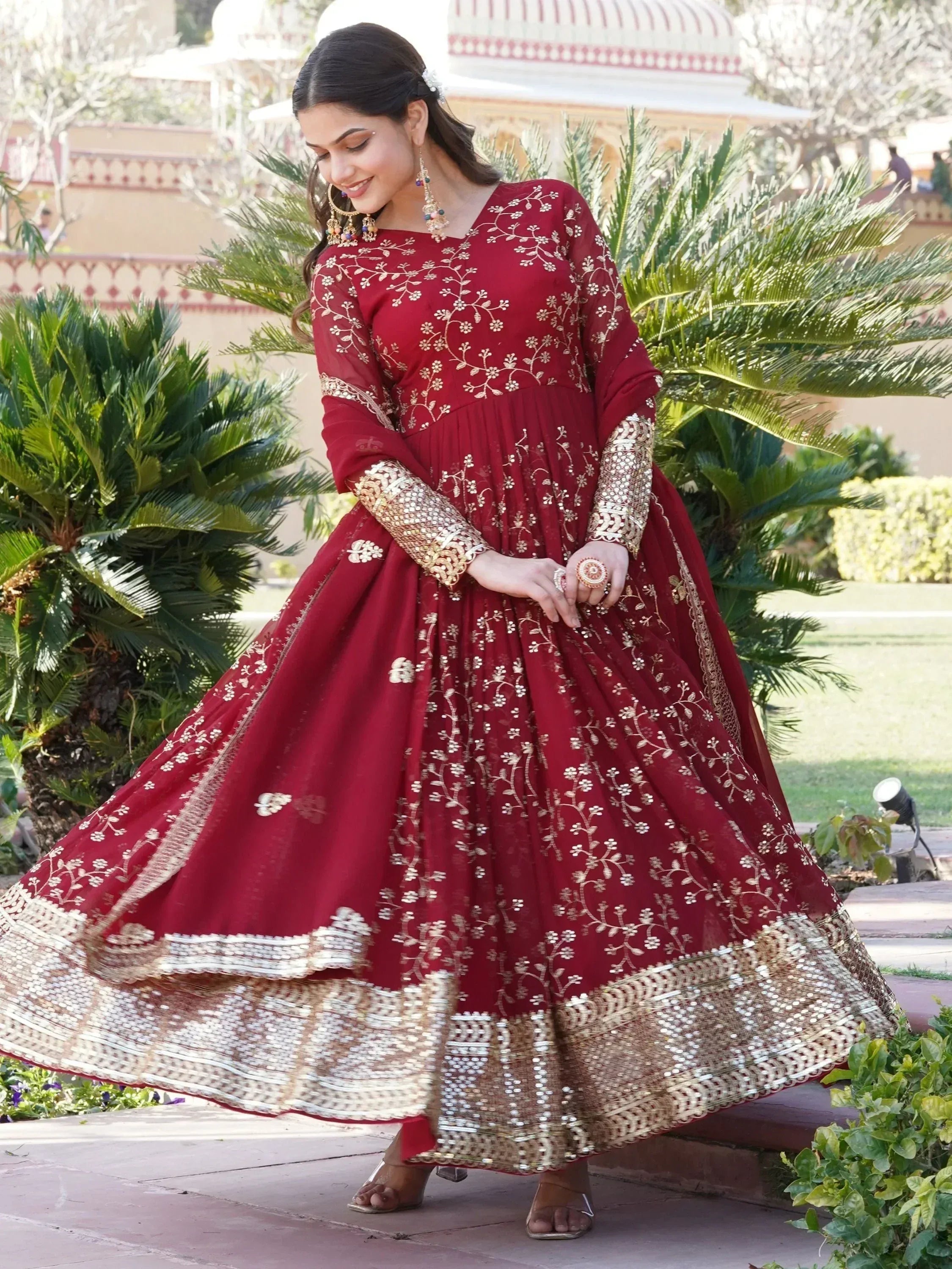 Maroon embroidered anarkali gown with gold floral detailing, perfect for Indian ethnic occasions.